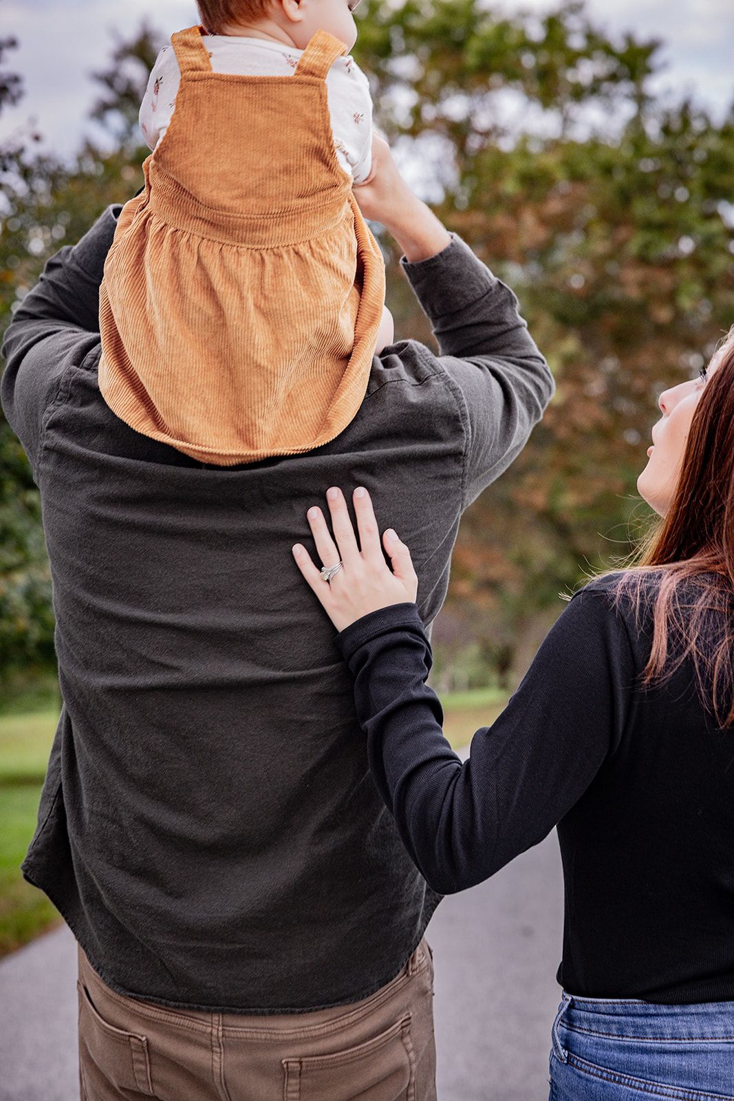 People in casual clothing interacting in an outdoor setting.