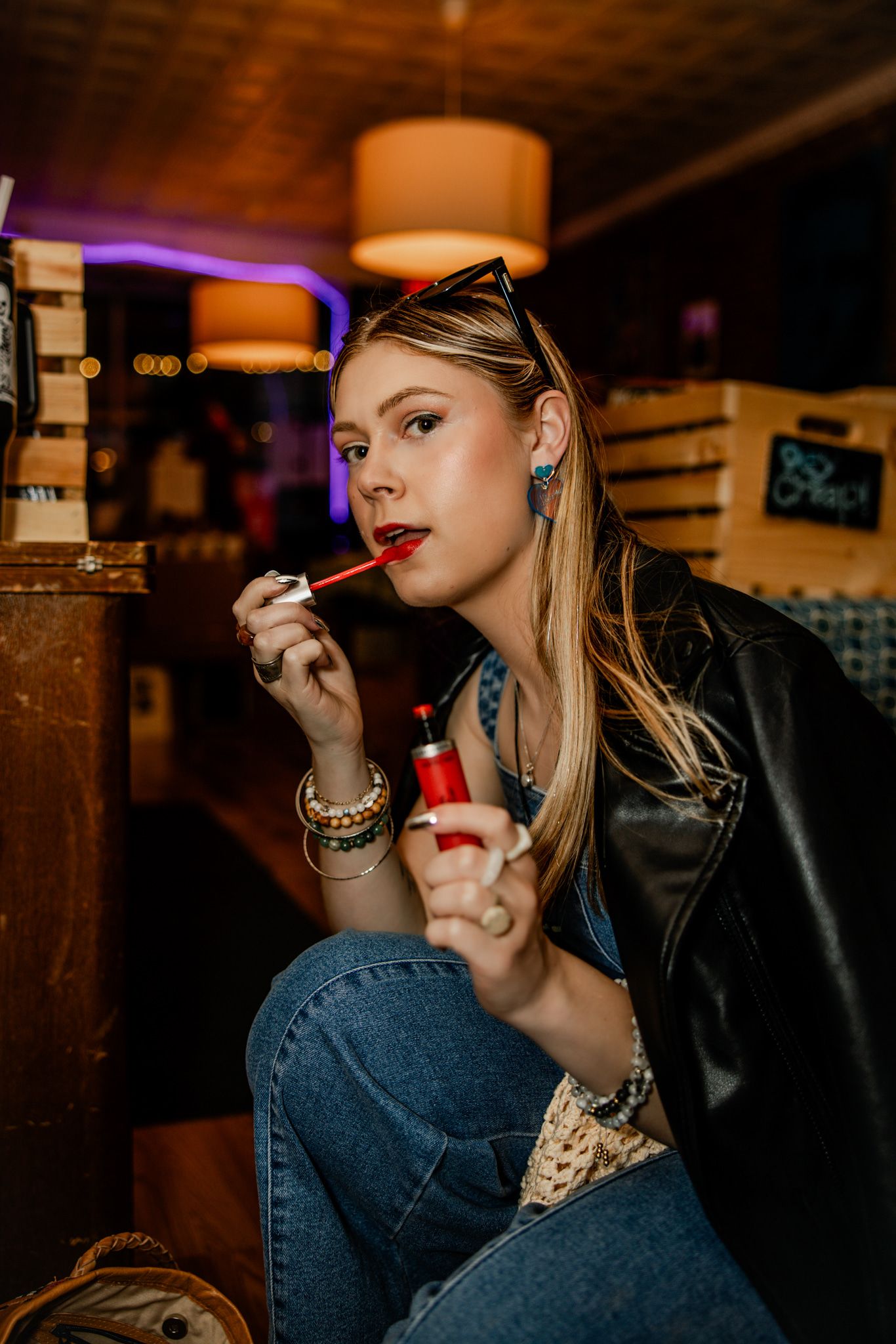 Stylish scene in dark bar with leather jacket and moody lighting.