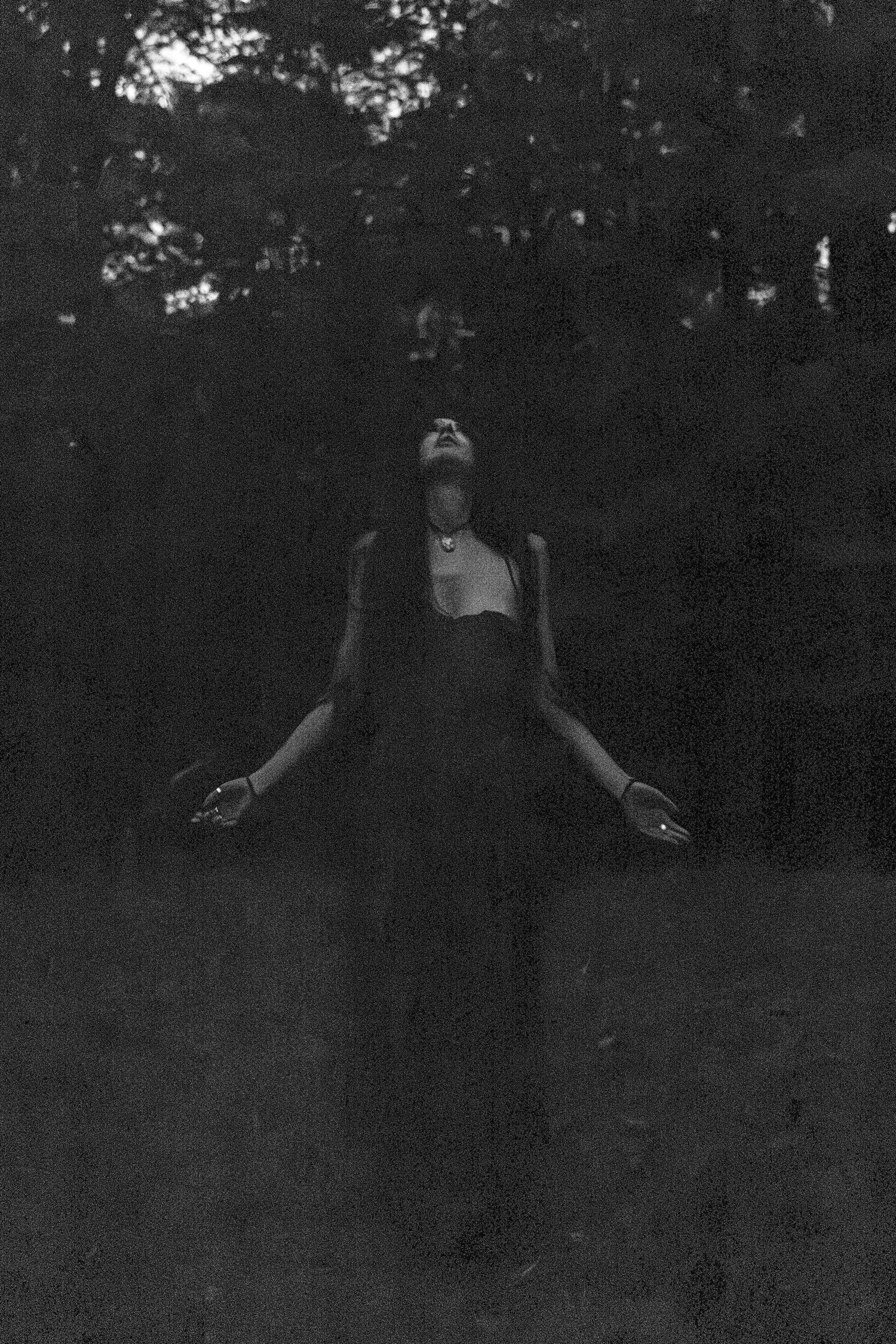 Dramatic black and white portraits taken outdoors at dusk with artistic silhouetting.