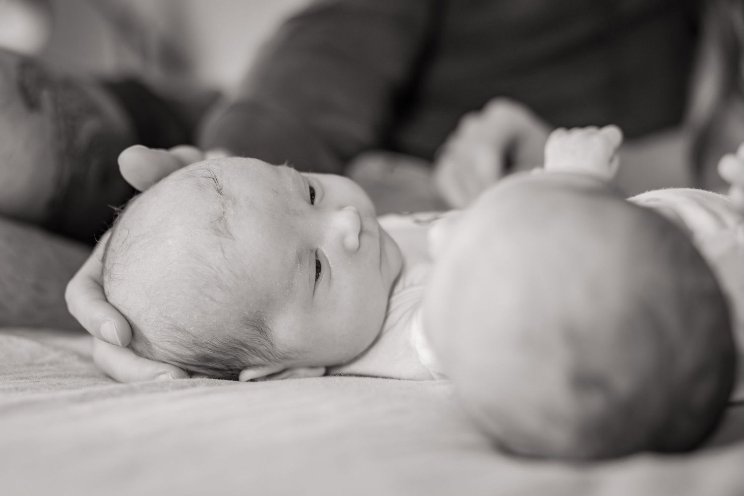 Black and white portrait series of a sleeping newborn baby.
