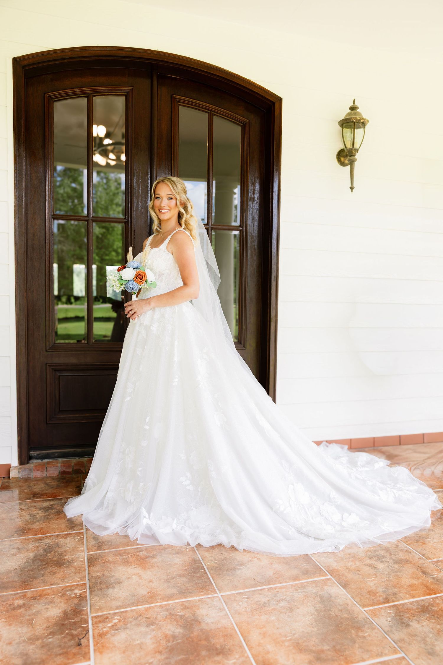 Elegant bridal portrait at a Mandeville, LA venue featuring a bride in a white lace wedding dress. Captured by wedding photographer near you