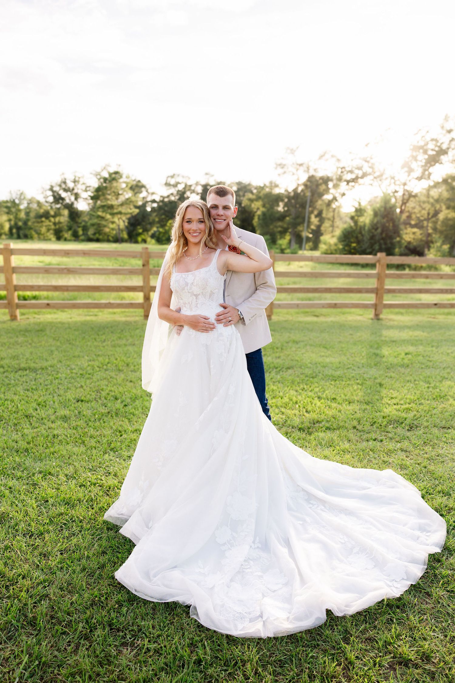 Outdoor wedding photography in Mandeville, LA showing a bride and groom in a rustic field setting near local Northshore Venues