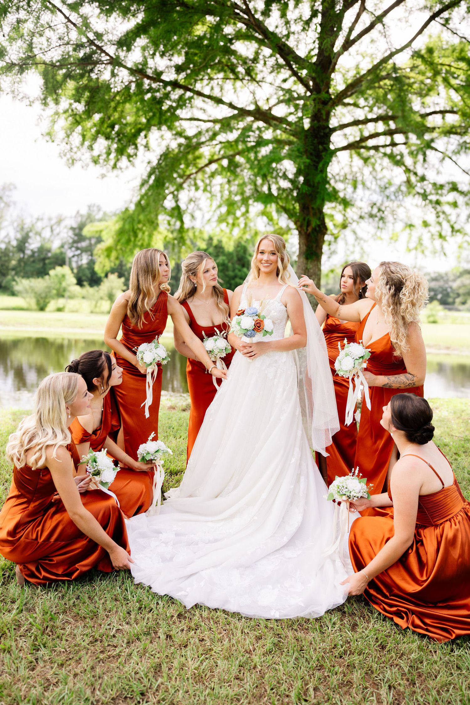 Mississippi Gulf Coast wedding photographer capturing a bride and her bridesmaids outdoors under southern live oaks. Wedding photographer