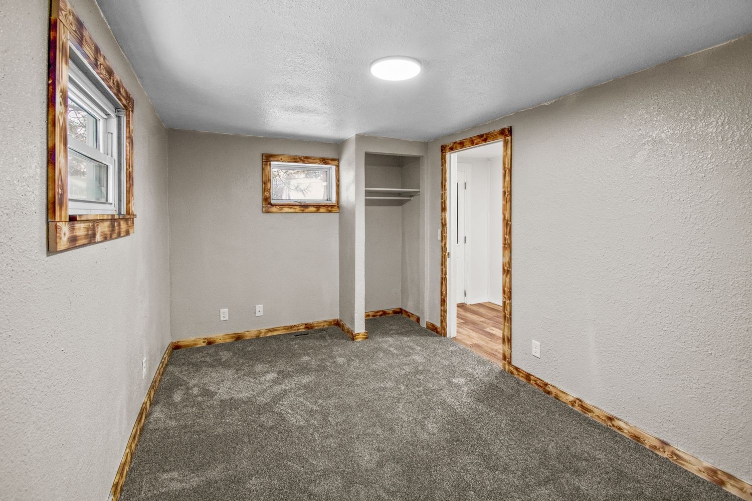 Spacious basement area featuring wood trim details and recessed lighting.