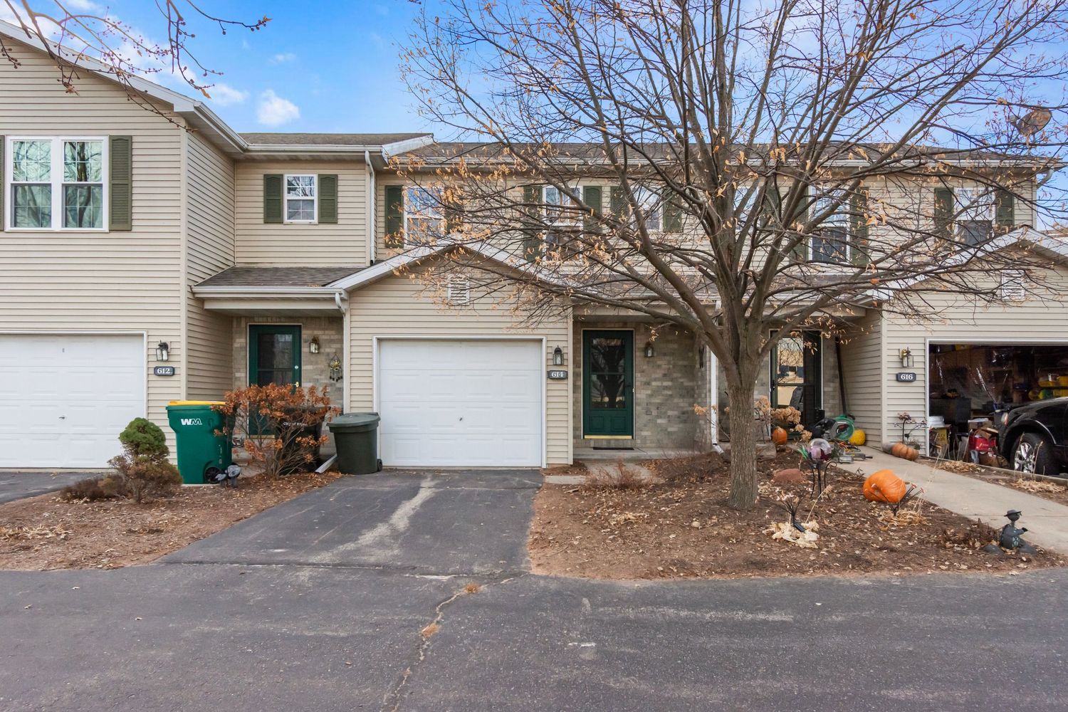 Exterior view of a residential neighborhood showing multiple houses with driveways and garages in winter.