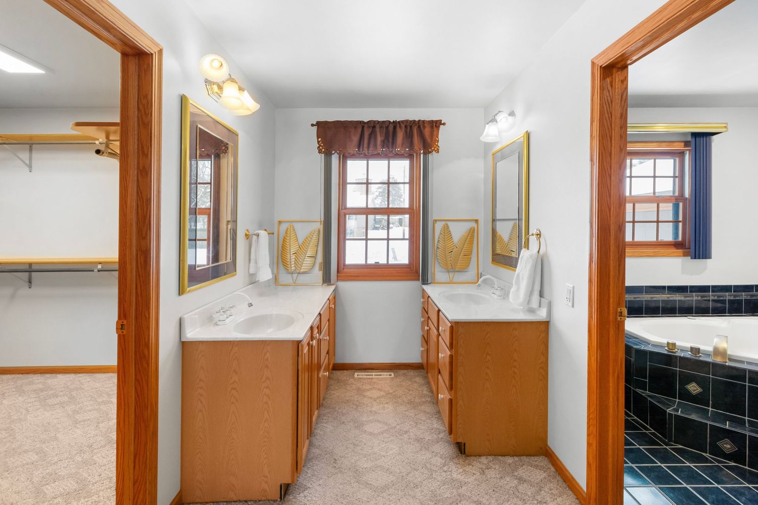 Long hallway with wood trim and multiple windows providing natural illumination.