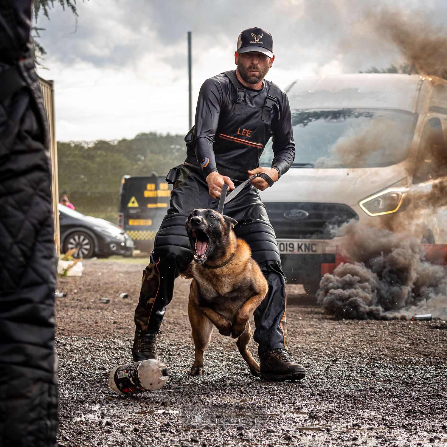 Training sequence of a working dog with smoke effects and dramatic lighting in the background.