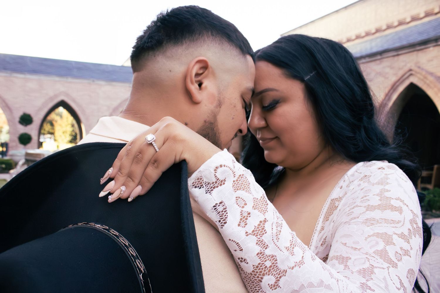 A tender moment between newlyweds as they embrace outdoors.