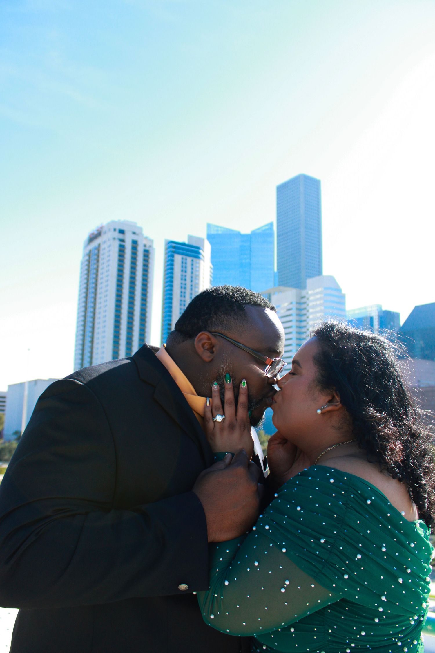 Couple sharing a romantic moment with downtown Houston skyline in the background.