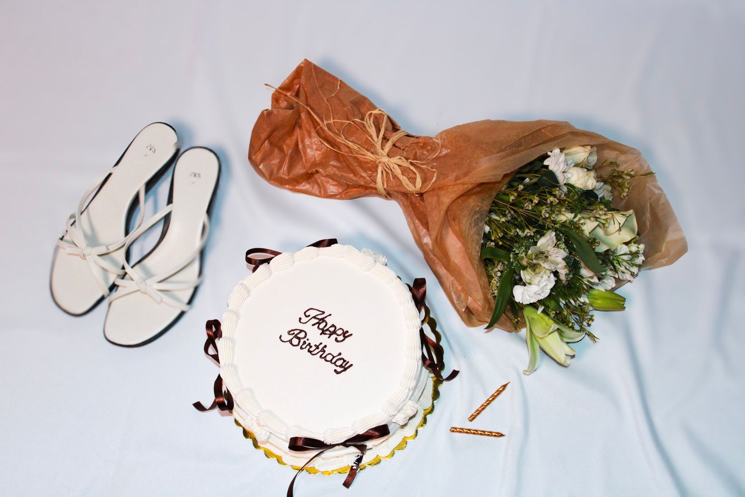Brown paper and white flowers are arranged on a light background.