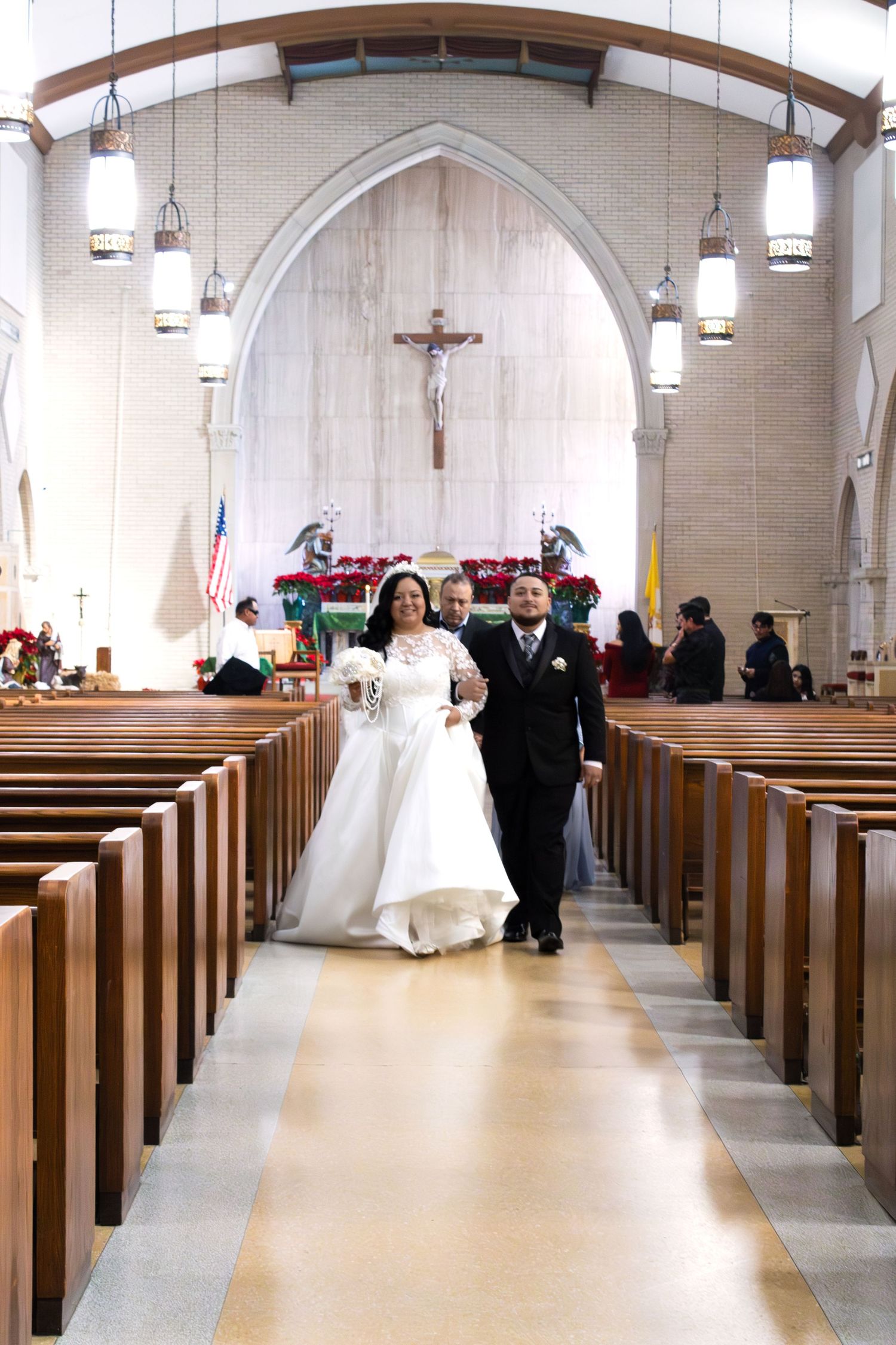 A joyful couple walking down the church aisle after their wedding ceremony.