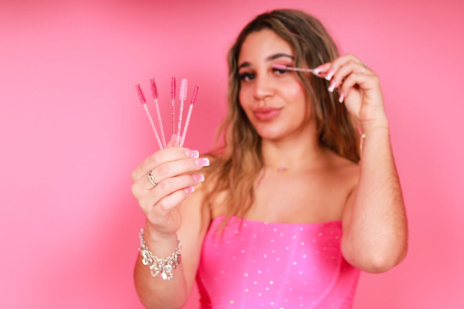 Series of joyful moments captured against bright pink wall.