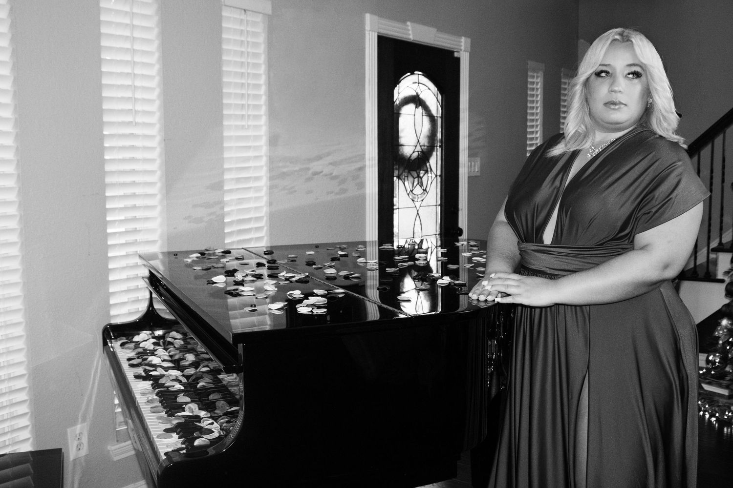 Artistic black and white portrait series near a piano and window.