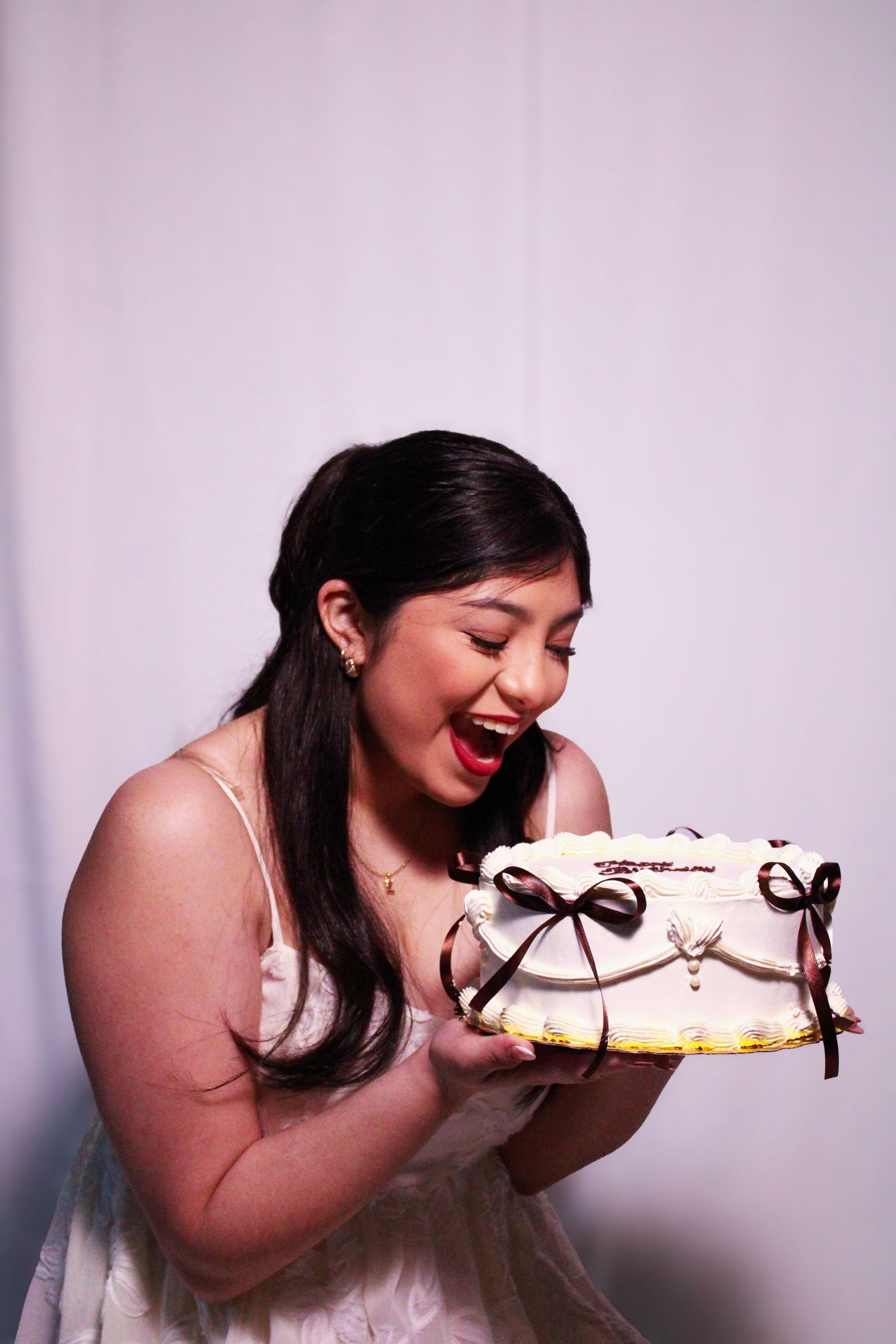 A series of joyful moments captured while eating cake against a pink backdrop.