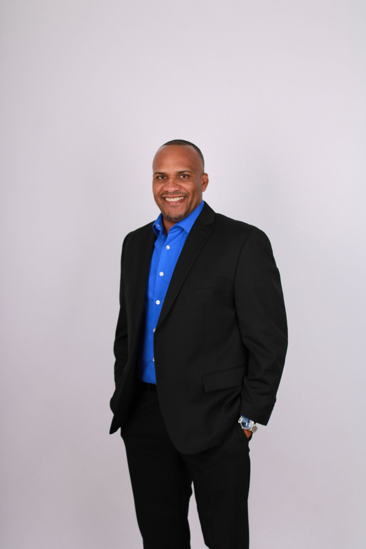 Business portrait series showing confident poses in formal attire against white backdrop.