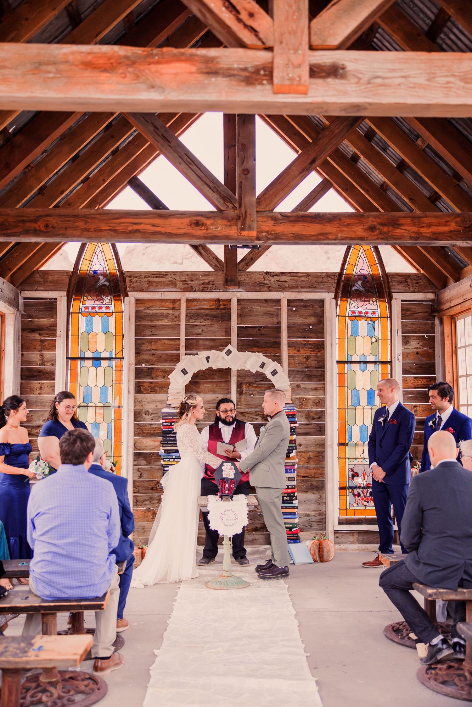 A sequence of wedding ceremony moments captured inside a rustic wooden chapel with stained glass windows.