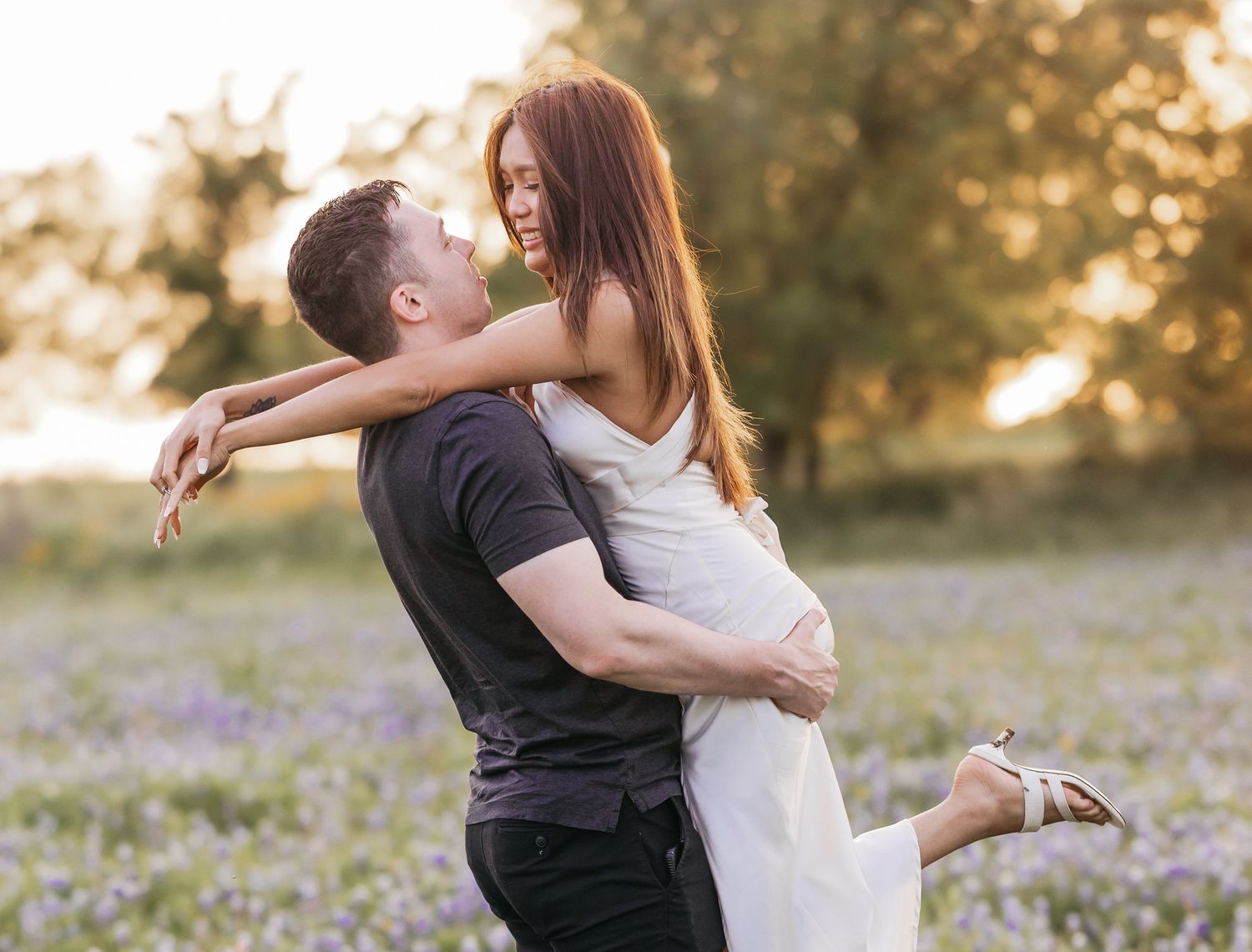 Couple sharing a romantic moment among blooming bluebonnets in a scenic Texas field near Salado