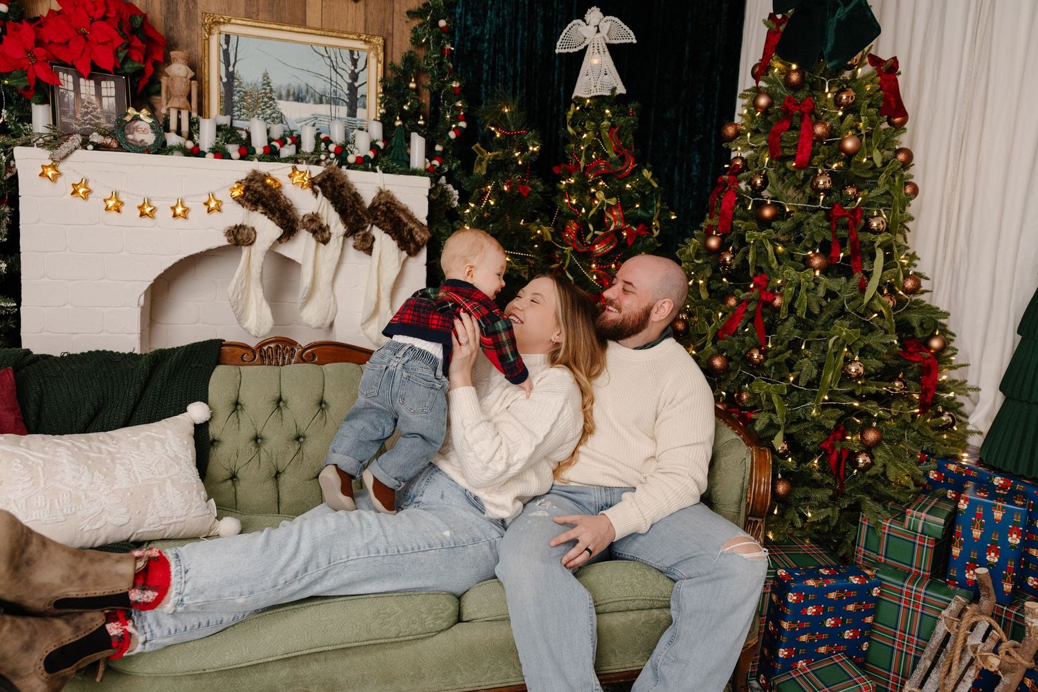 A festive Christmas scene with a decorated tree, couch, and people relaxing in a cozy living room setting.