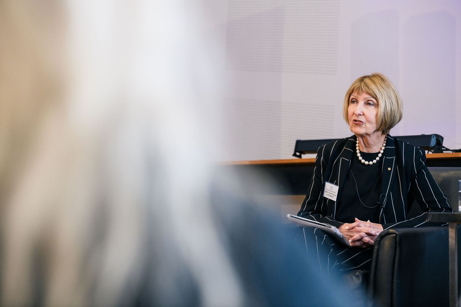 Professional woman presenting during female executives' conference. Creative corporate event photography.