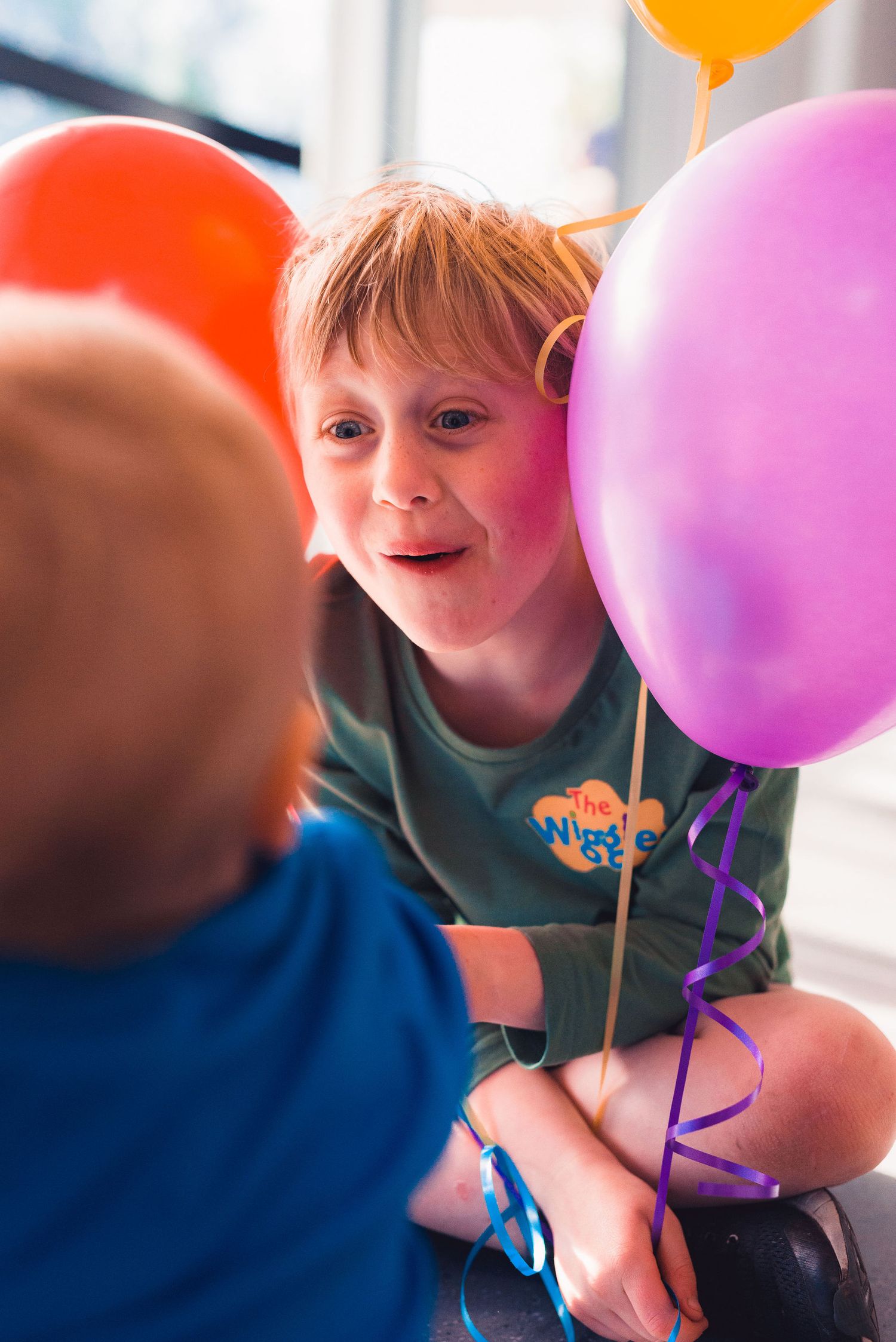 A sequence of photos showing a balloon being inflated with colorful orange, pink and purple balloons visible.