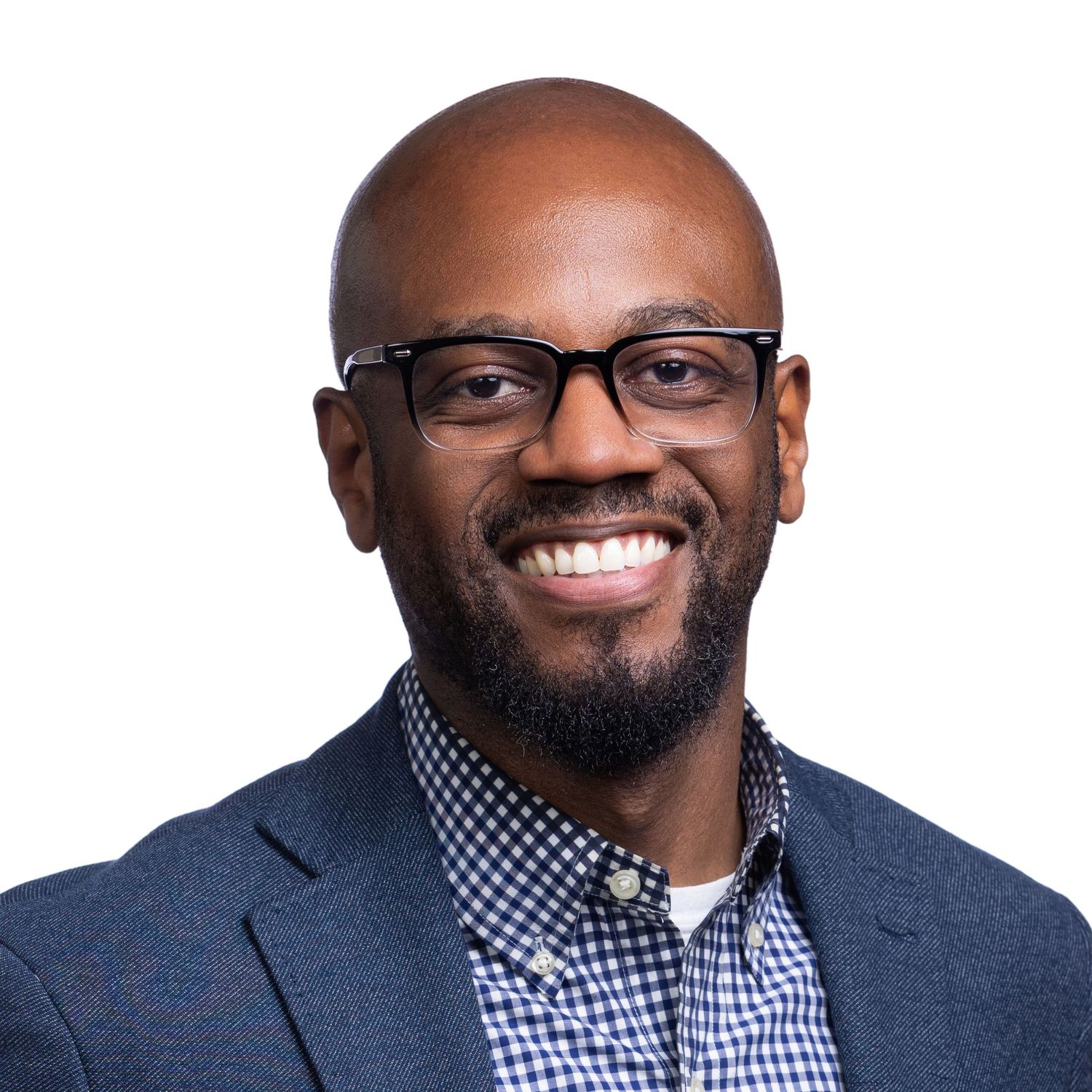 Professional headshots showing a person wearing glasses and a checkered shirt smiling in various poses against a light background.