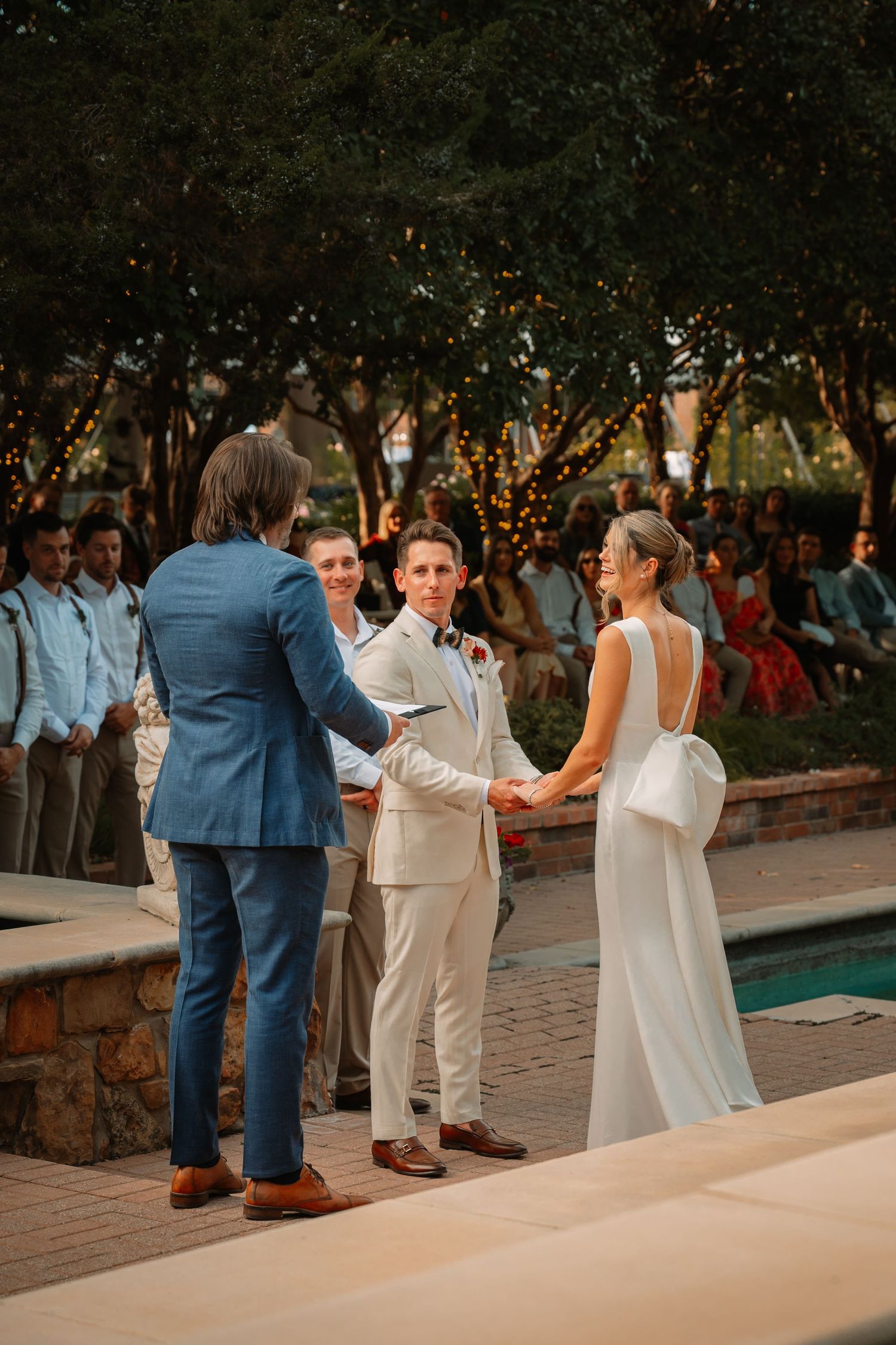 Weatherford Texas wedding ceremony at Clark Gardens in fall, Bride and groom holding hands before saying I do