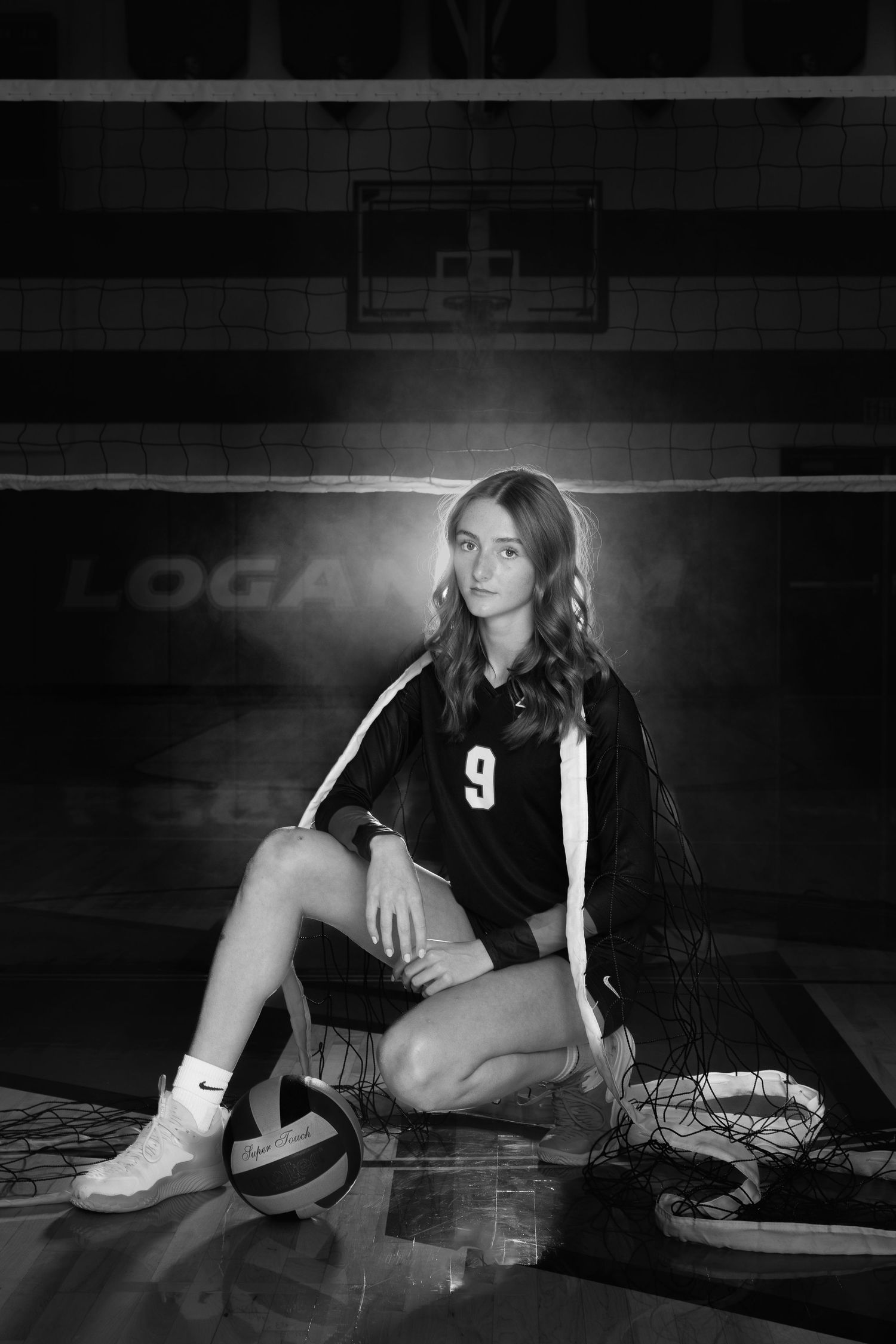 A dramatic black and white photo series shows a volleyball player in uniform #9 posing on the court floor.