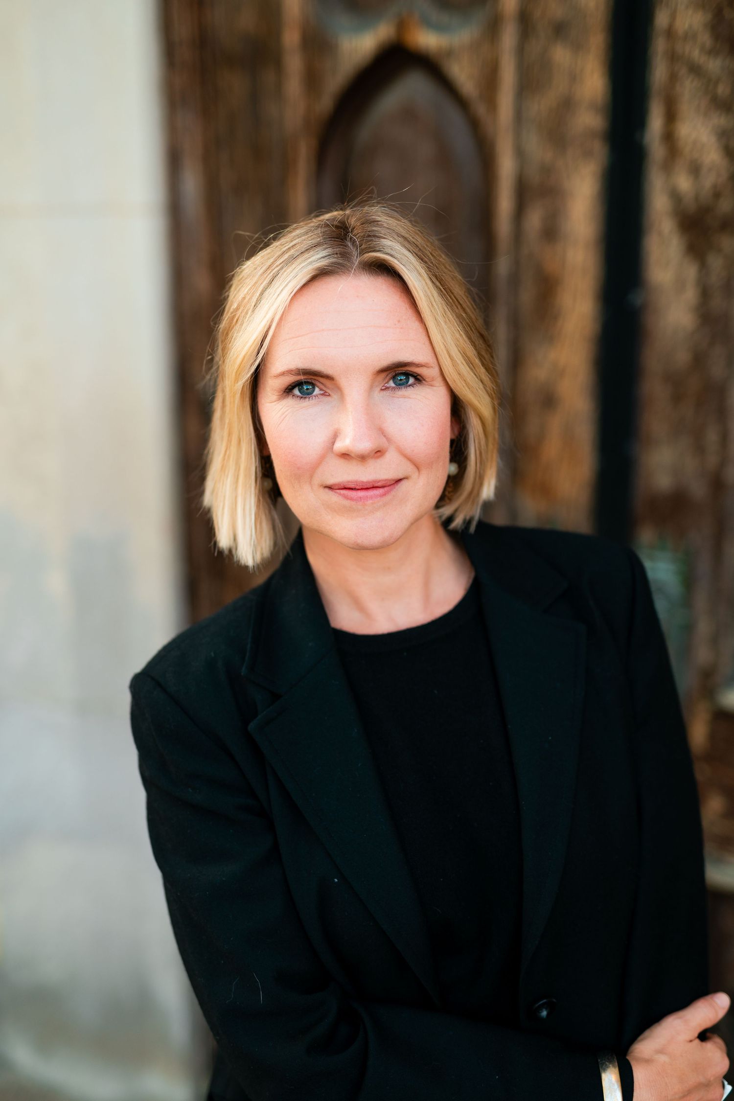 A professional headshot in grand rapids showing different expressions against a dark rustic wooden background.
