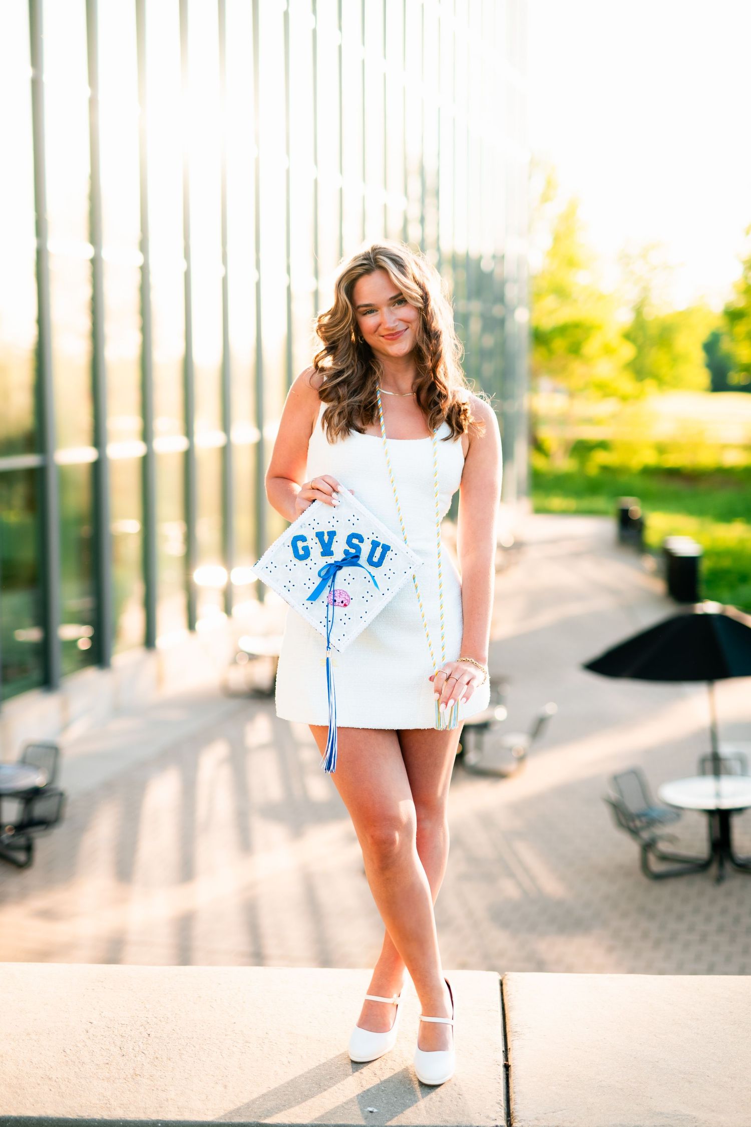 Woman in white t-shirt and shorts poses on sunny urban walkway in three different playful stances.