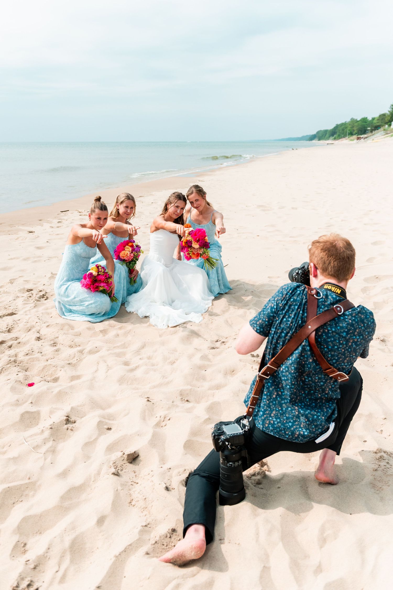 A photographer captures subjects lying on a sandy beach in a series of candid shots.