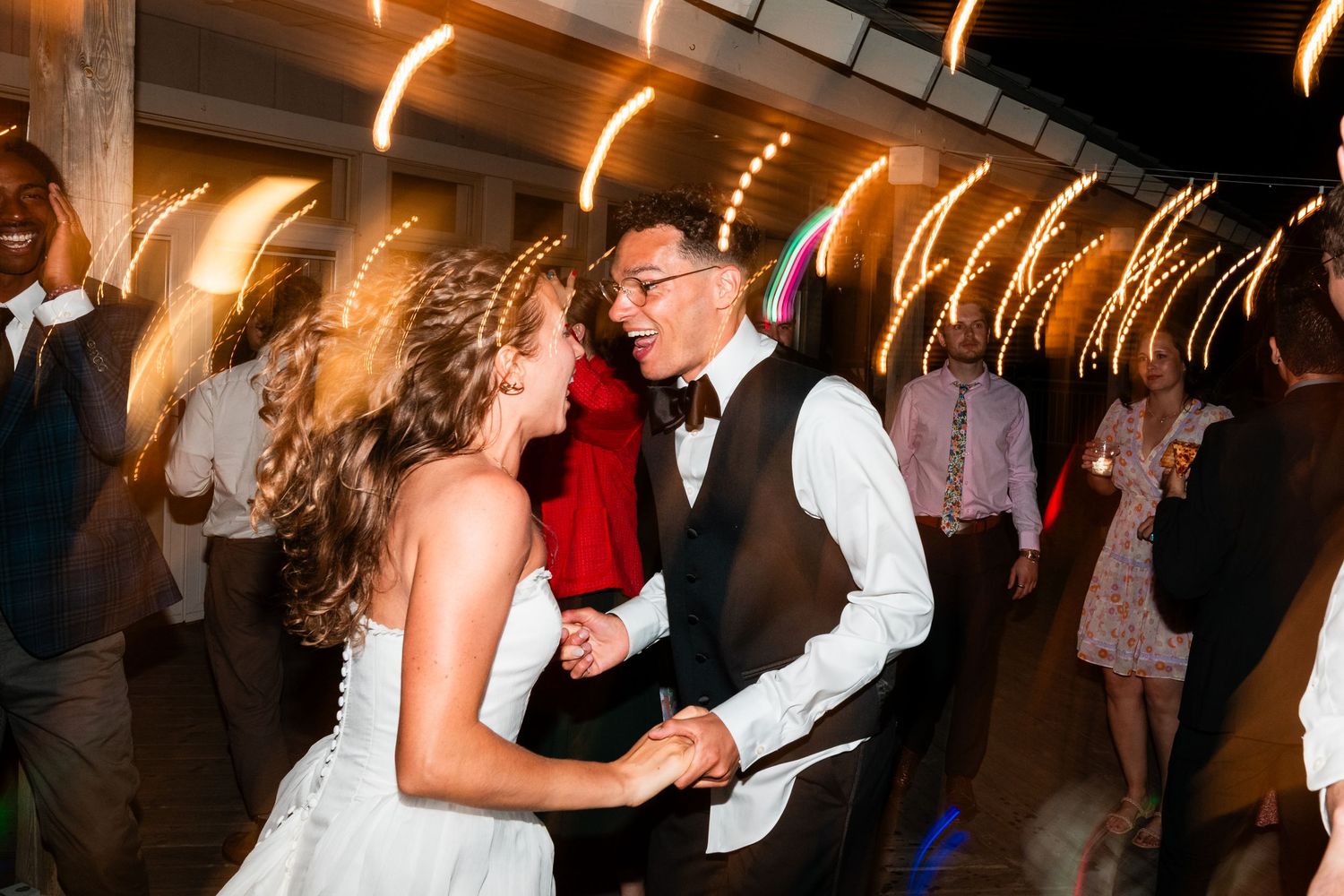 Couples dancing together at a Michigan wedding reception with warm lighting and a festive atmosphere.