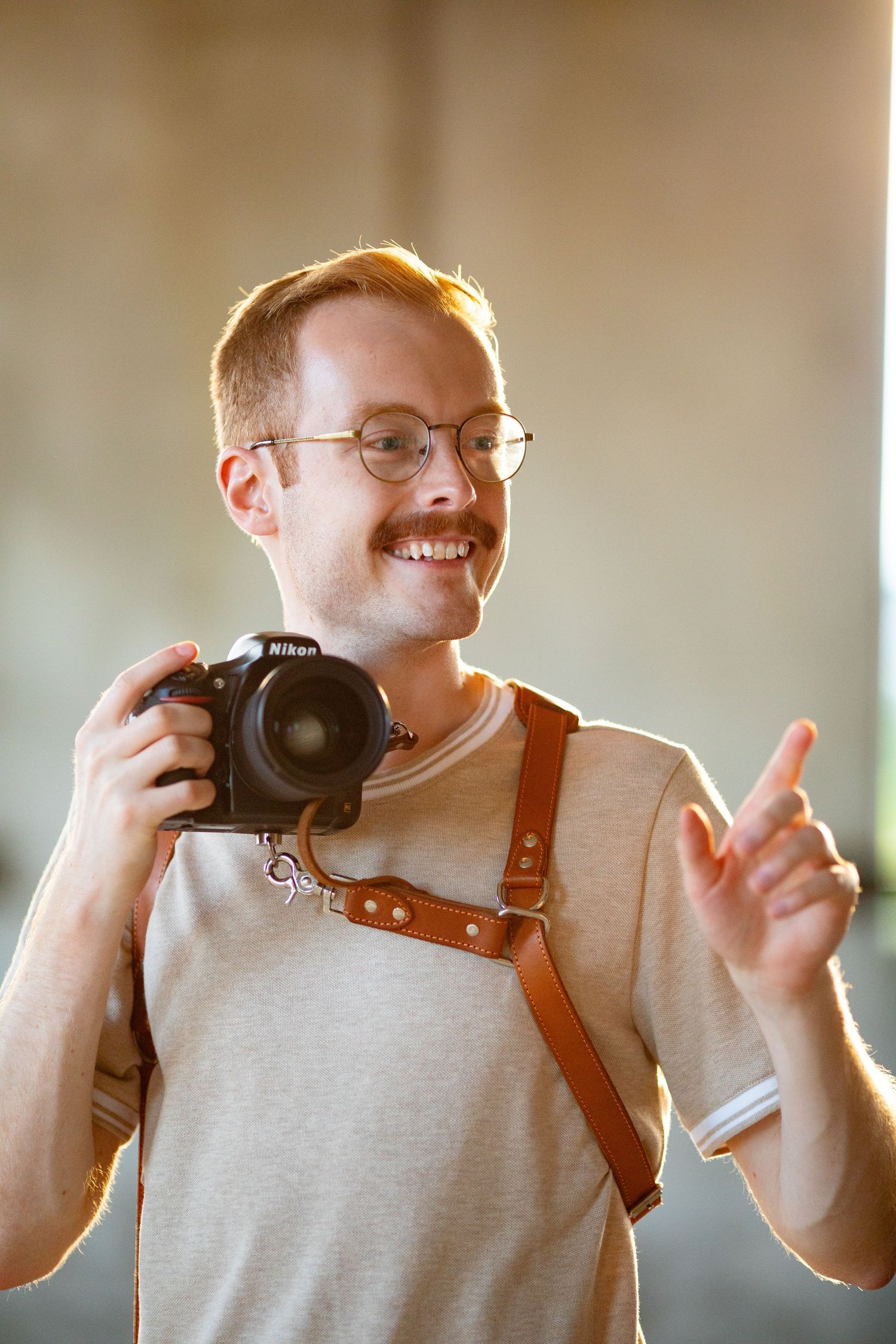 Four sequential photos showing someone wearing glasses and a brown leather camera strap while gesturing expressively.