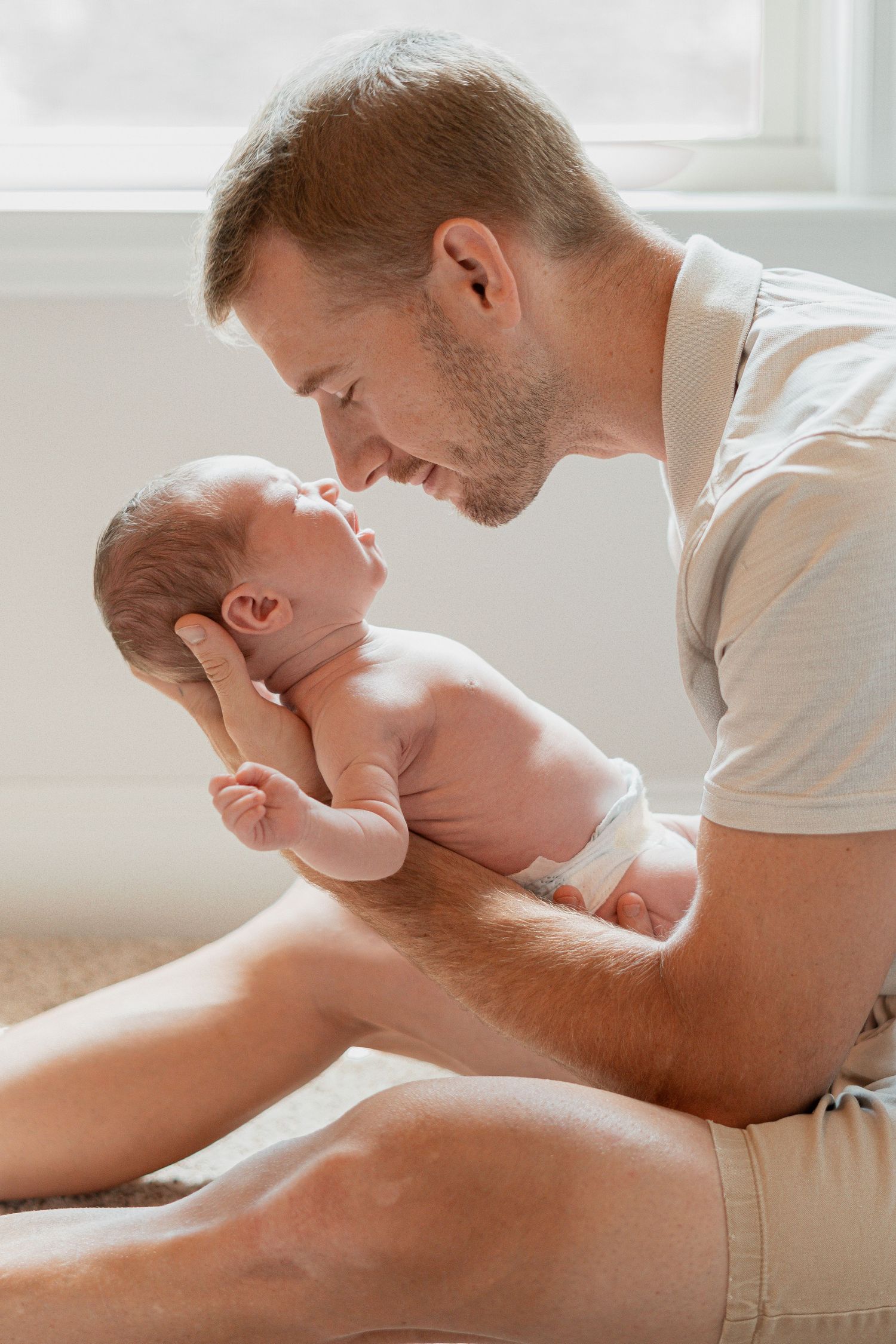 Tender moments between parent and baby during indoor lifestyle photoshoot in Augusta, GA.