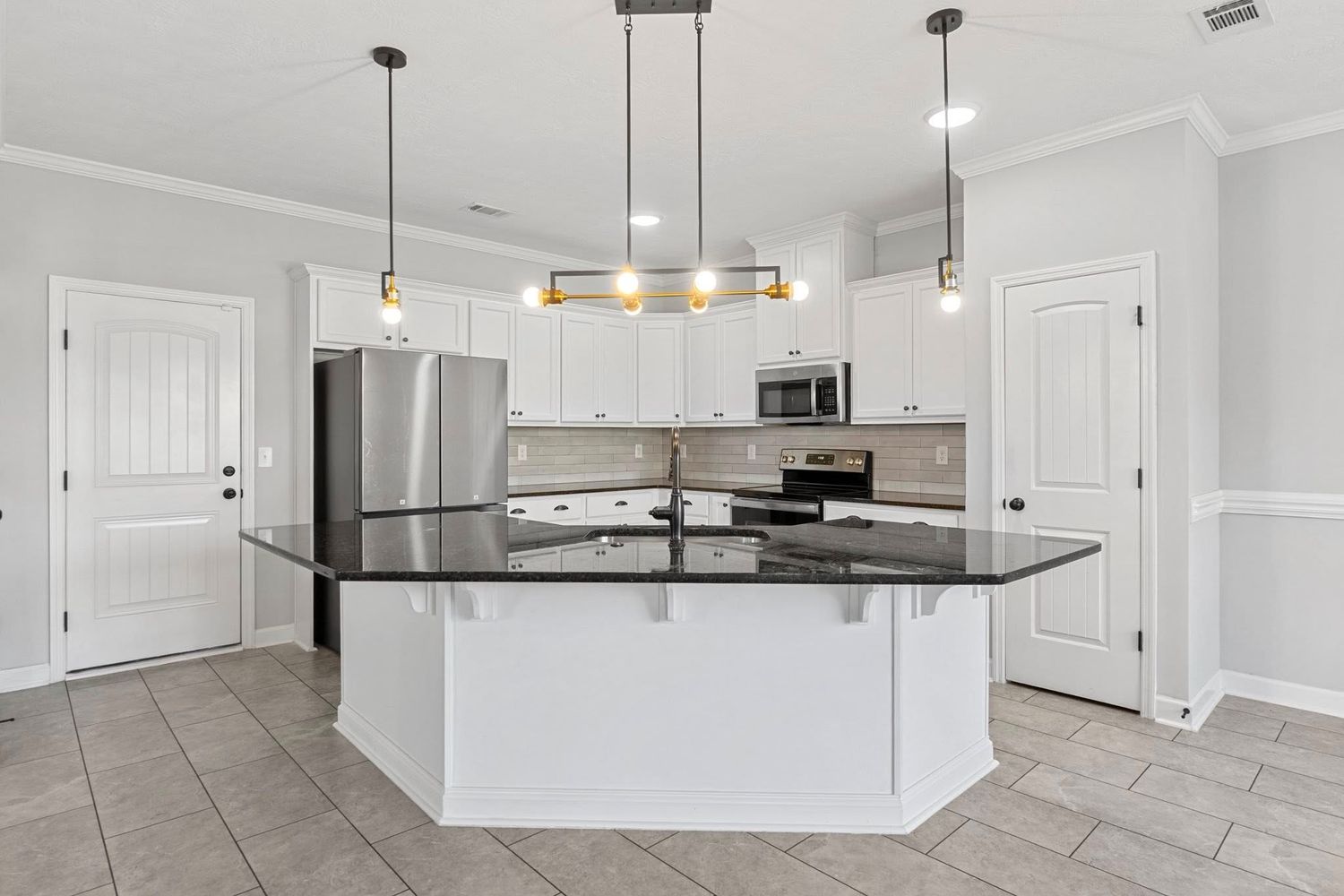Open concept living space with modern lighting fixtures and white trim details for real estate photography in Augusta, GA.