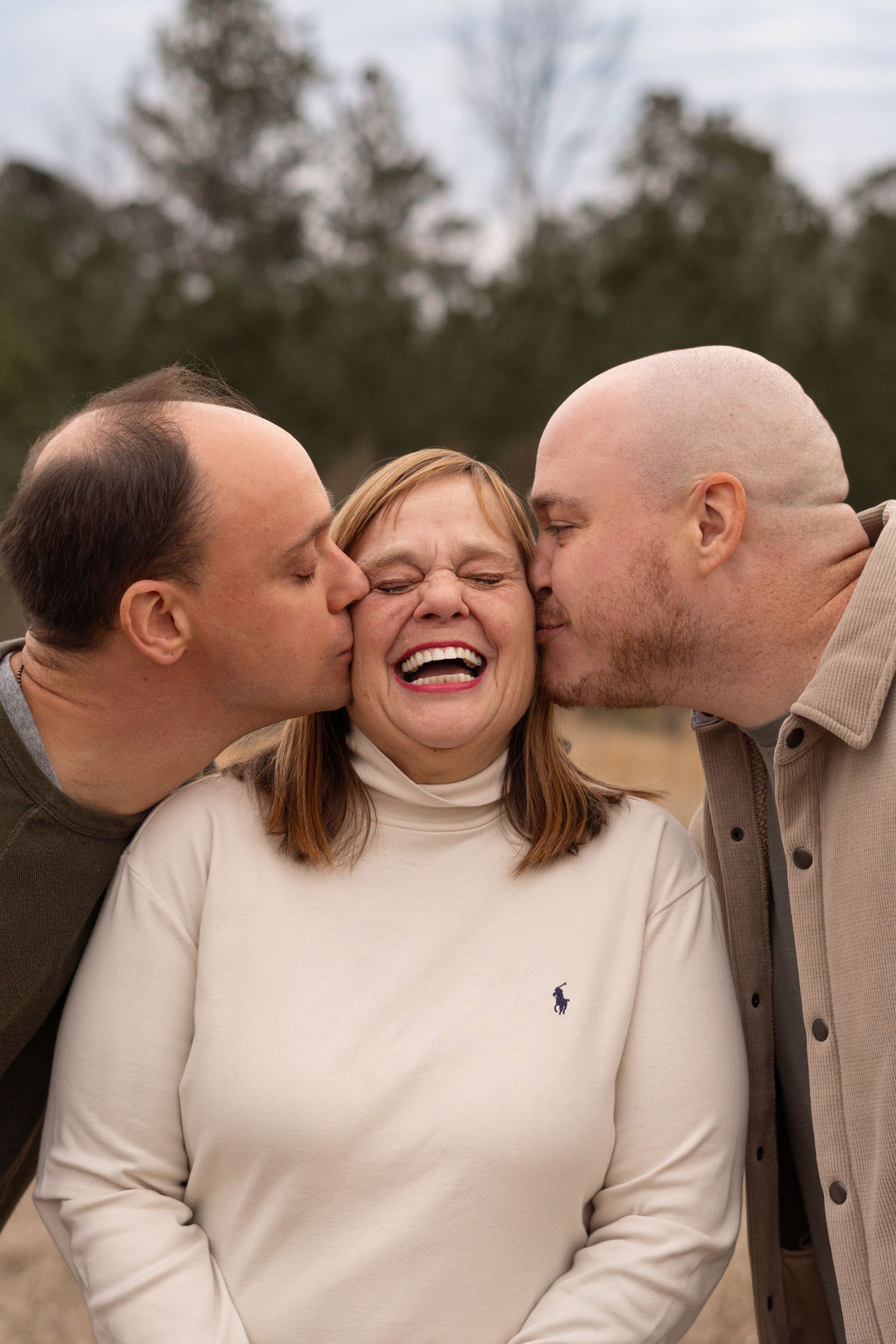 A heartwarming family moment captured outdoors in neutral winter clothing in Evans, GA.