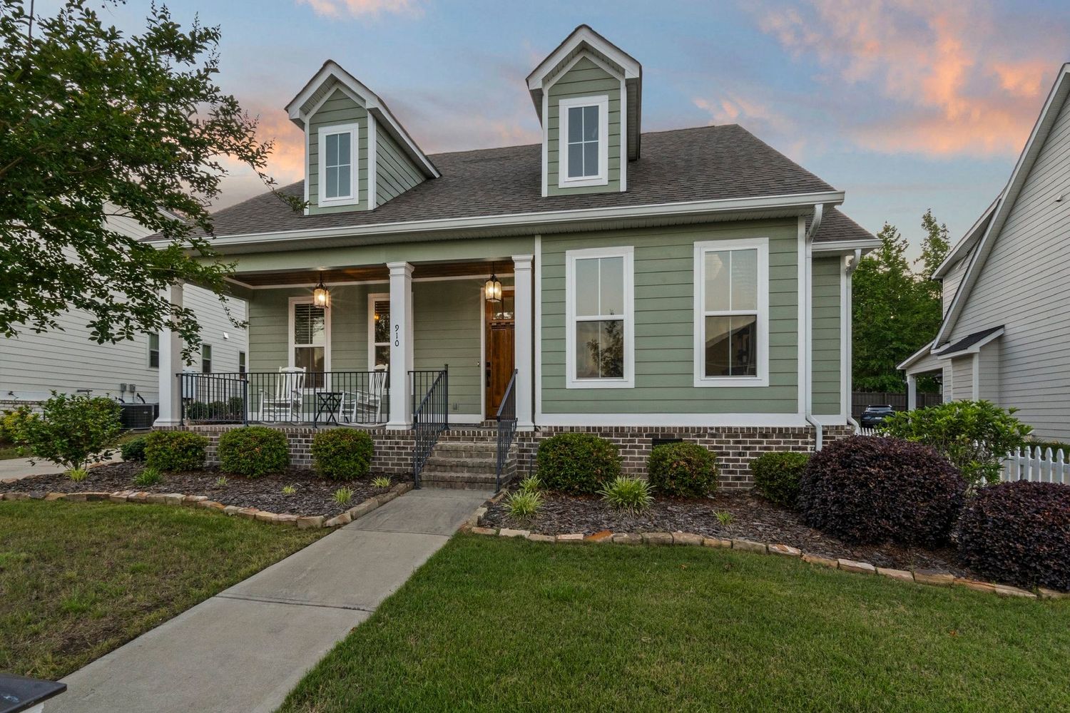 Modern craftsman style home exterior with gray siding and white trim at sunset for real estate photography in Augusta, GA.