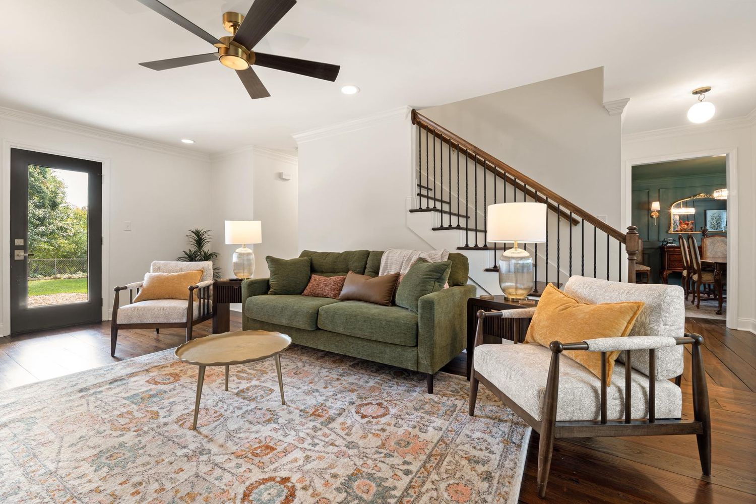 Spacious living room with ceiling fan, modern furniture and hardwood floors for real estate photography in Augusta, GA.