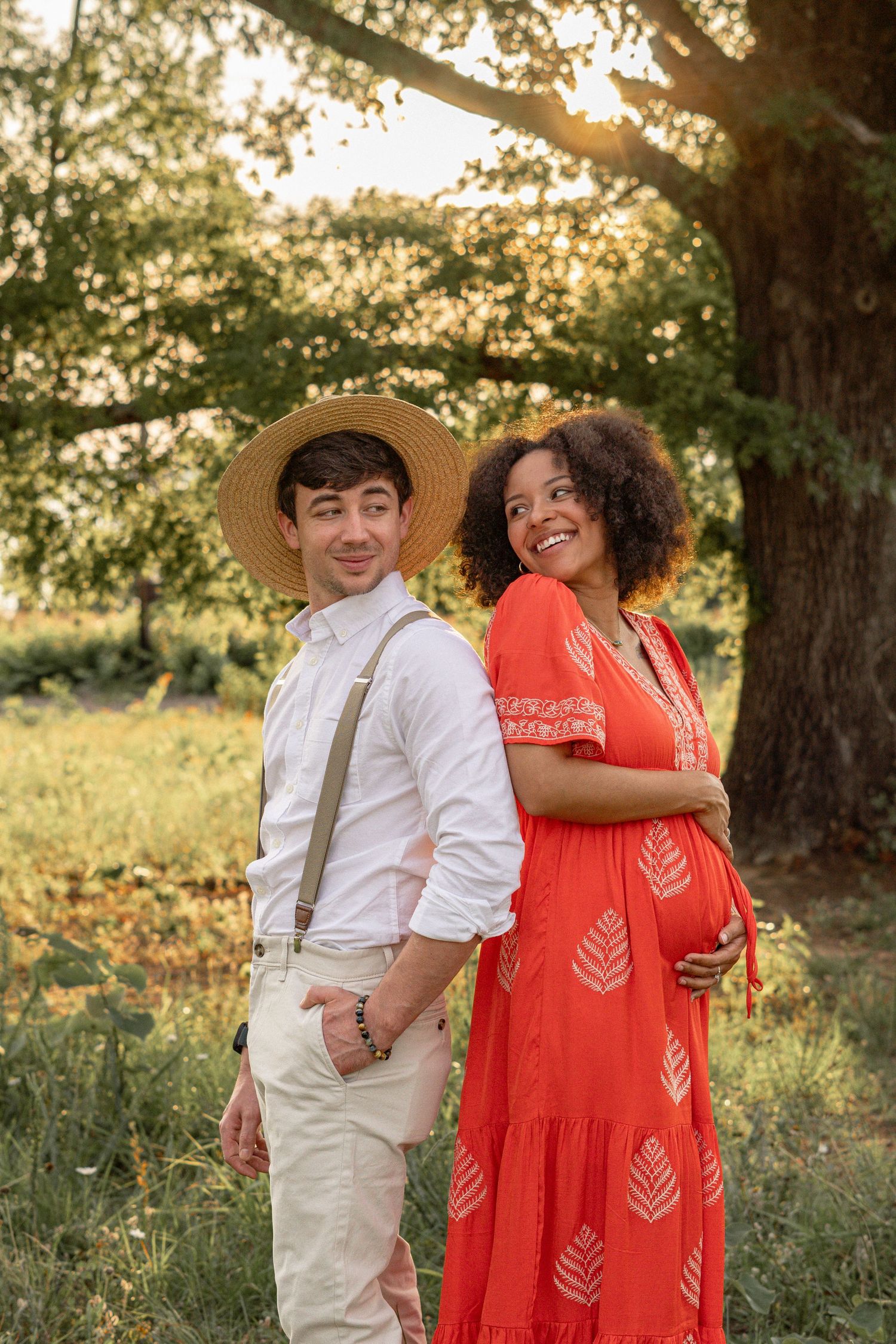Couple's outdoor photo session with red dress and white outfit at golden hour in Evans, GA.