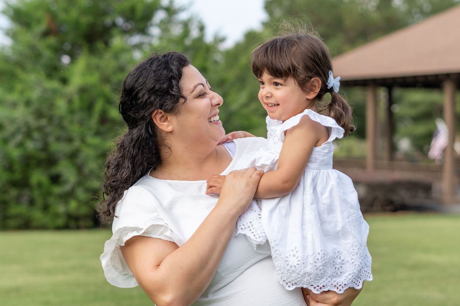Joyful outdoor family photography session in a park setting.