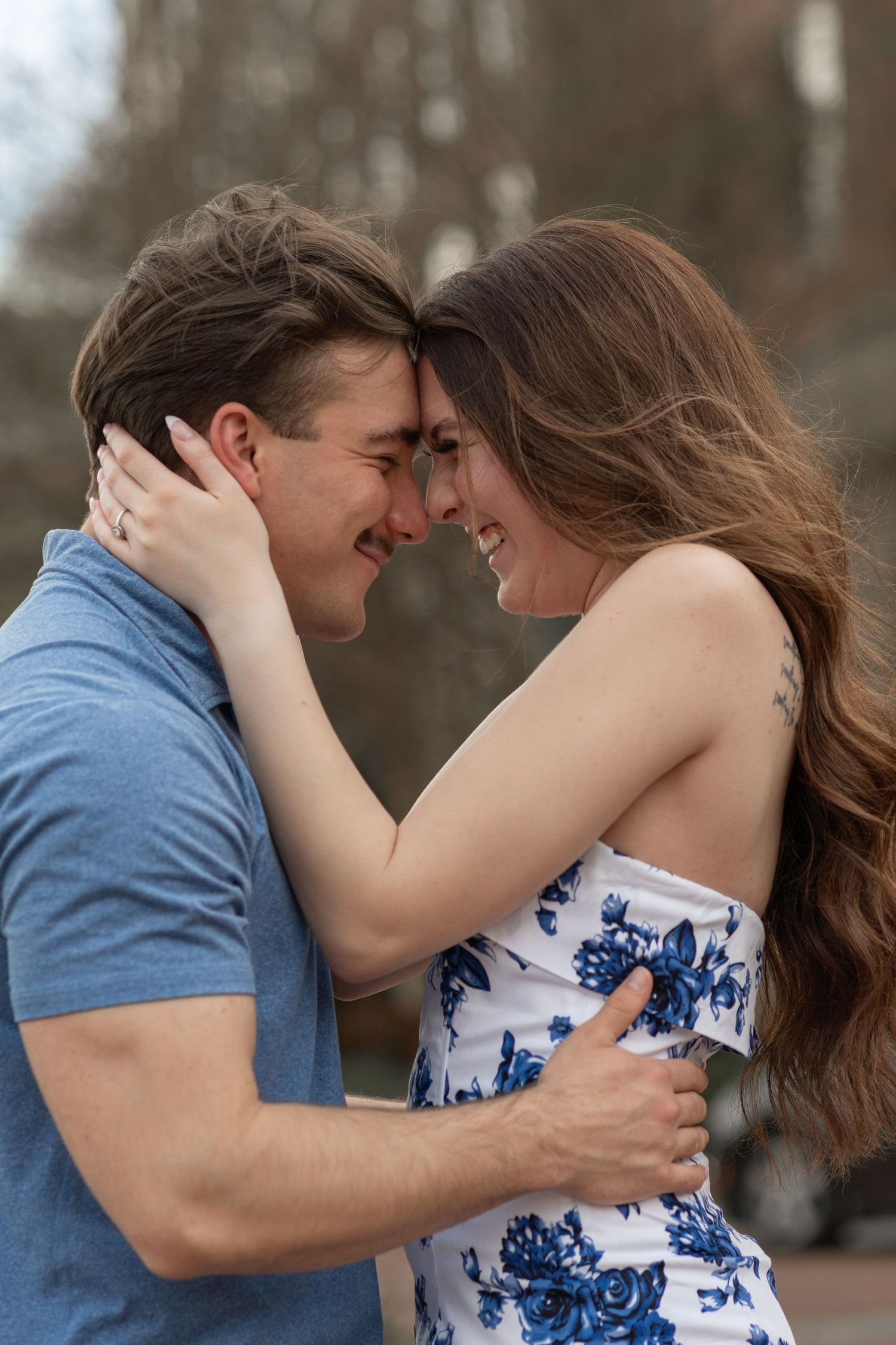 An intimate moment between a couple wearing blue captured during an outdoor photoshoot in Augusta, GA.