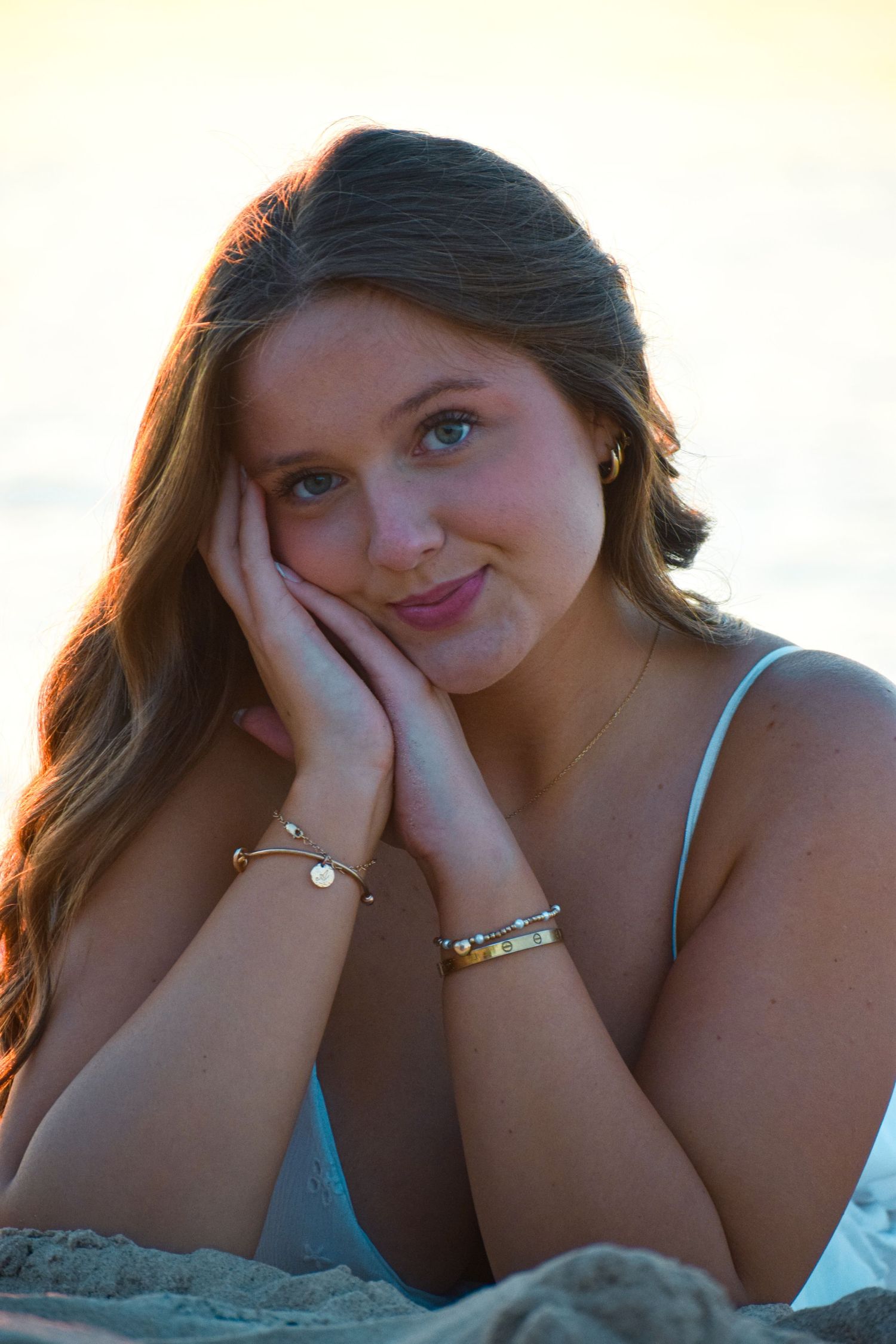 Beach portrait with soft natural lighting and gentle expression.