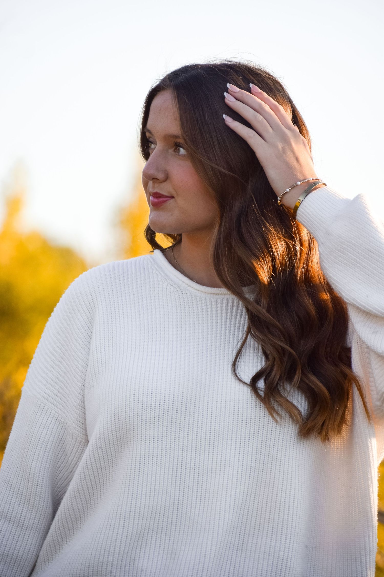 Close-up shots of white ribbed sweater styling against bright background.