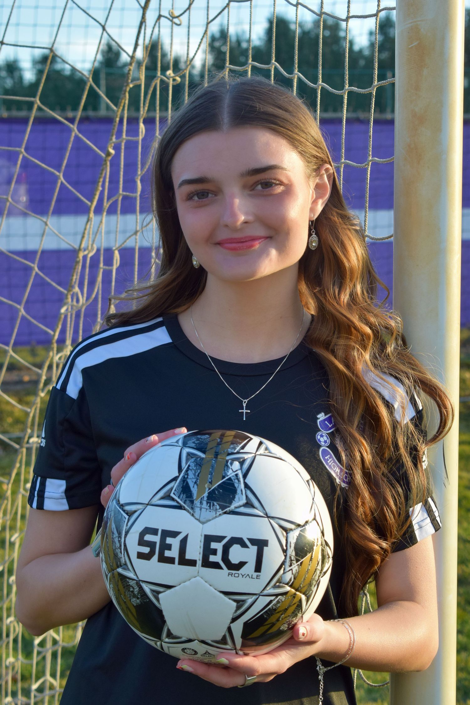 Soccer team members pose with Select brand balls for team photos.