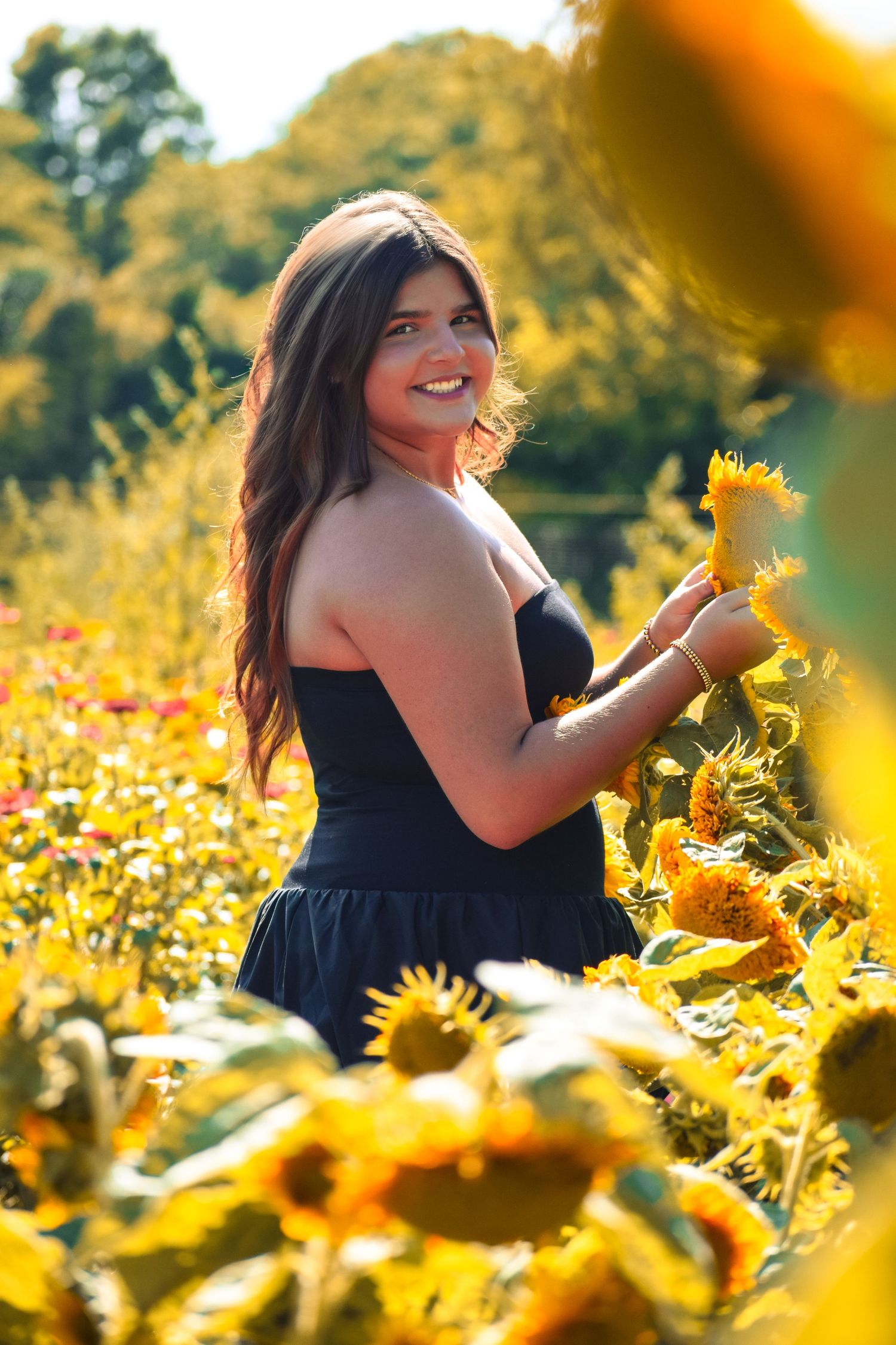 Candid moments captured in a vibrant sunflower field on a sunny day.