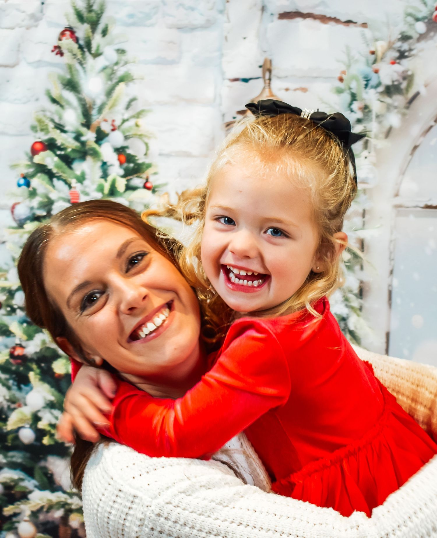 Holiday portrait with festive decorations and Christmas tree in background.