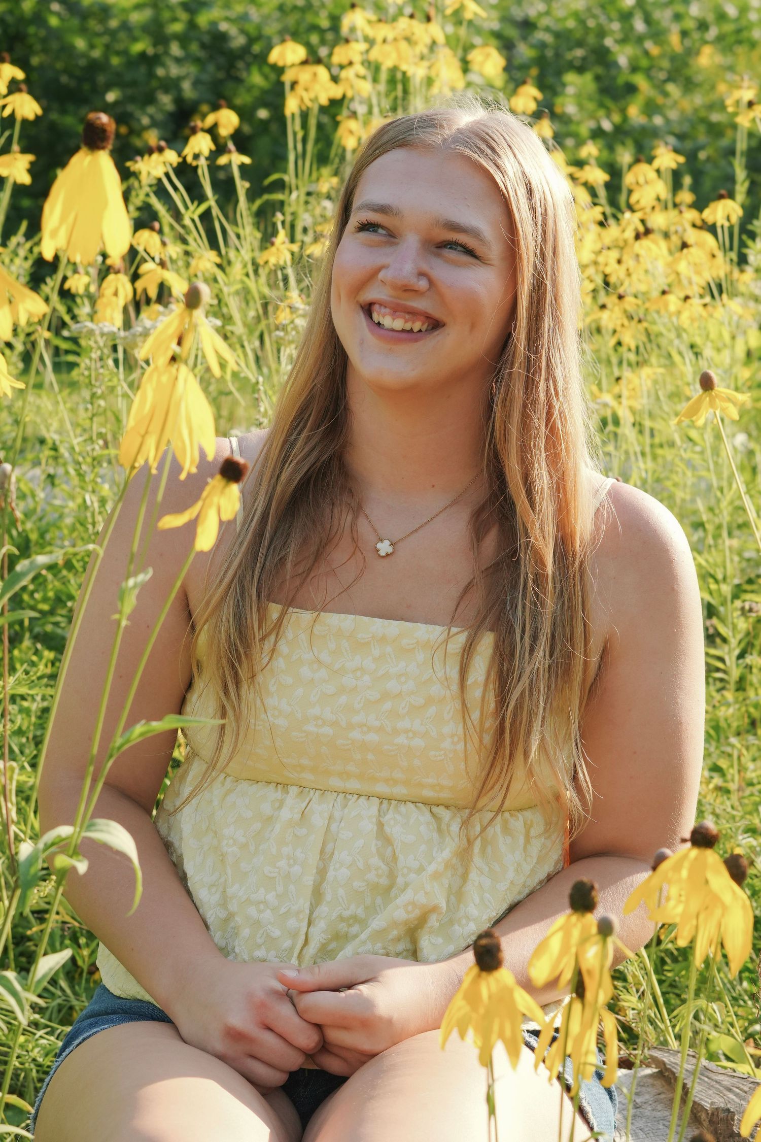 Portrait series in a field of yellow wildflowers on a sunny day.
