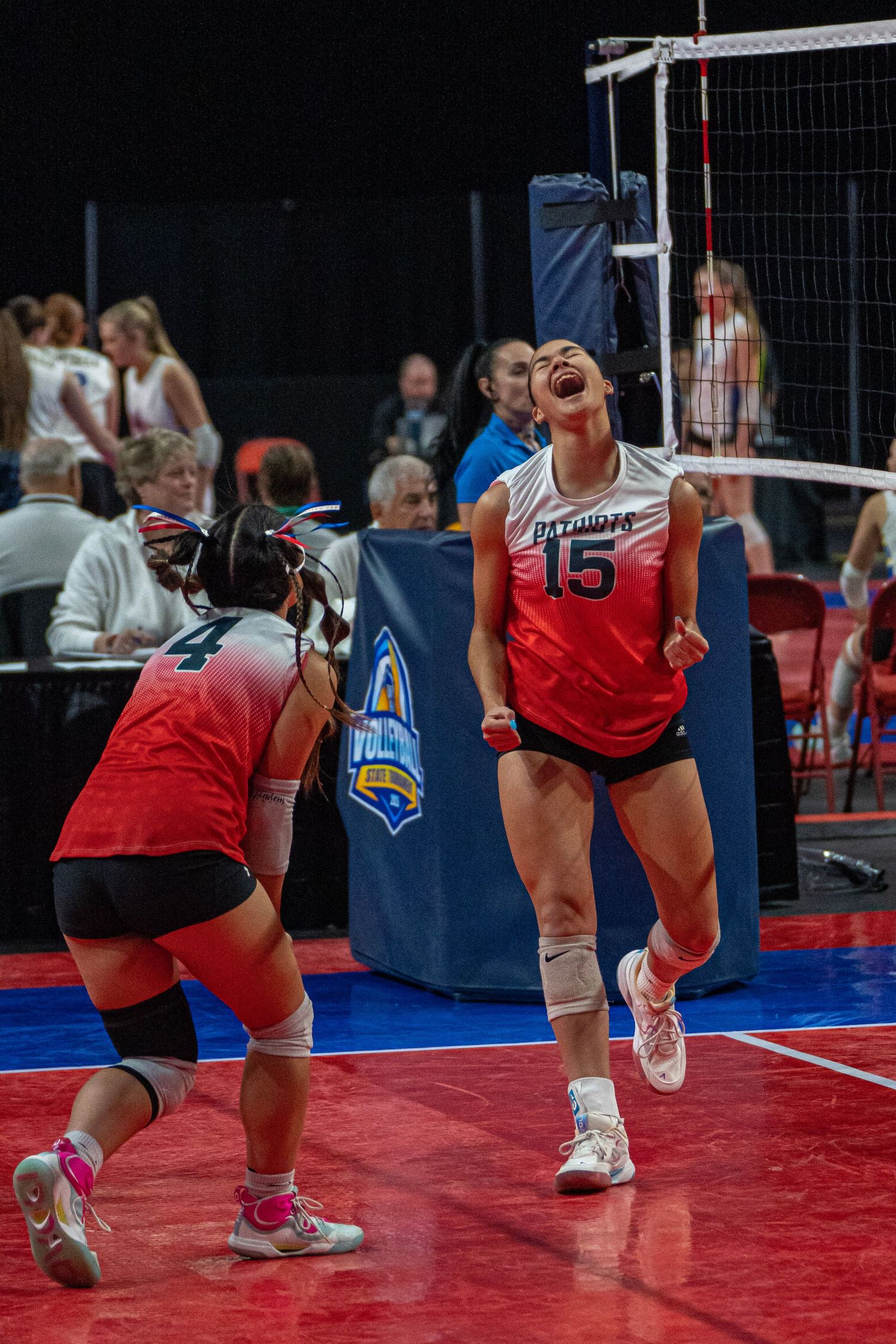 Sequence of volleyball players diving and reaching for the ball during an intense match on a red court.