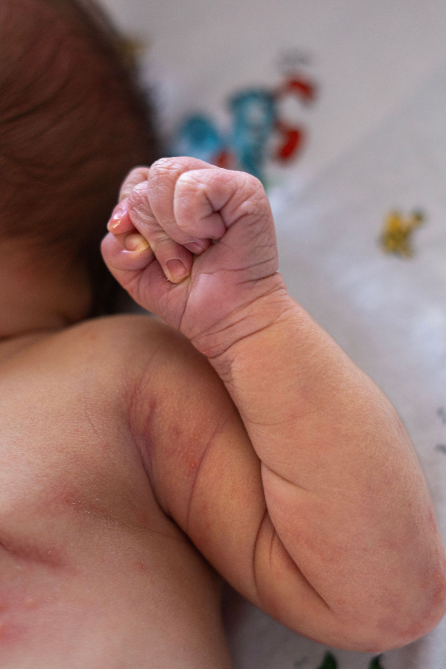 Close-up sequence of tiny baby hand with delicate fingers.