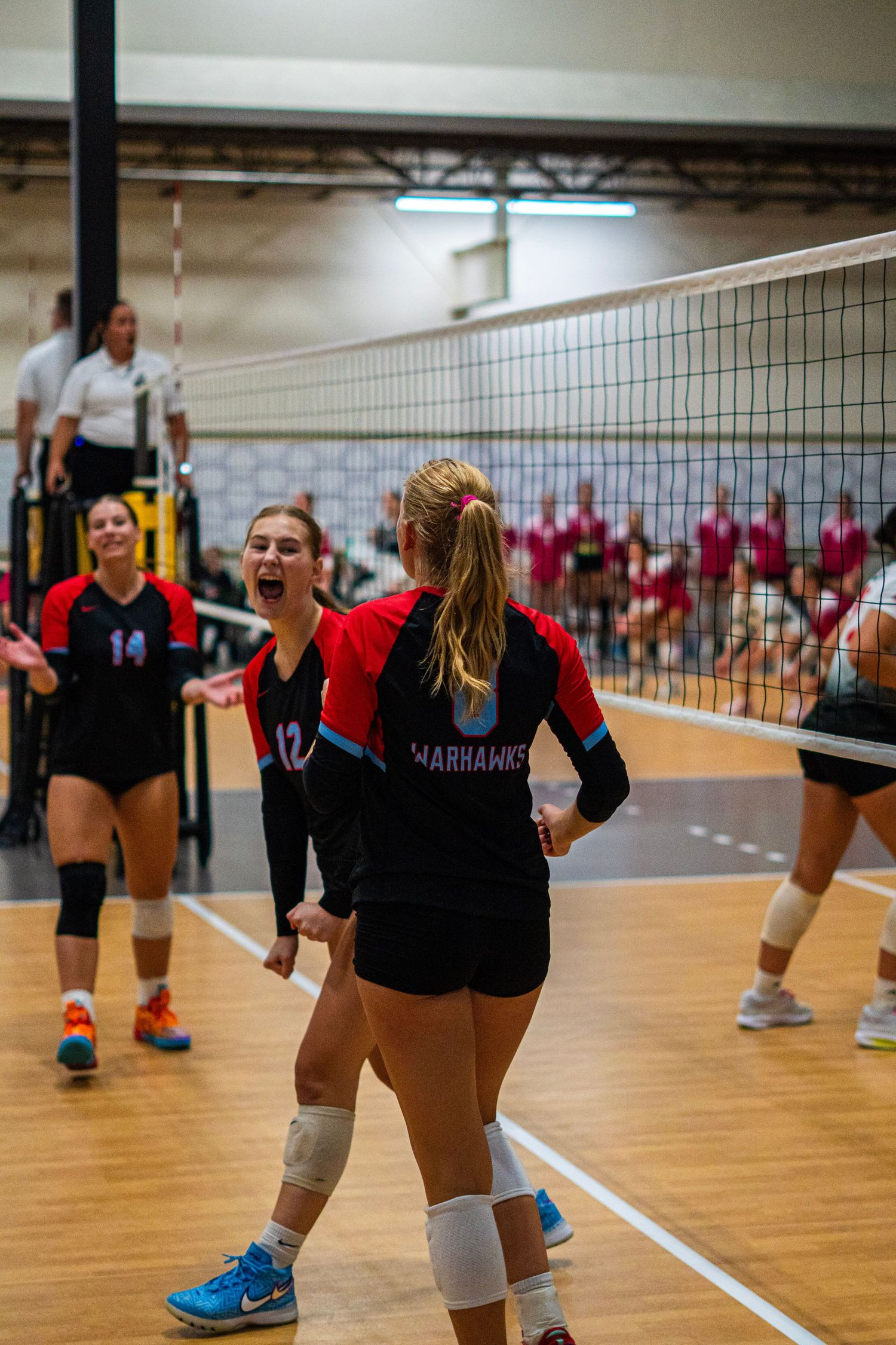 Players in action during a competitive indoor volleyball match.