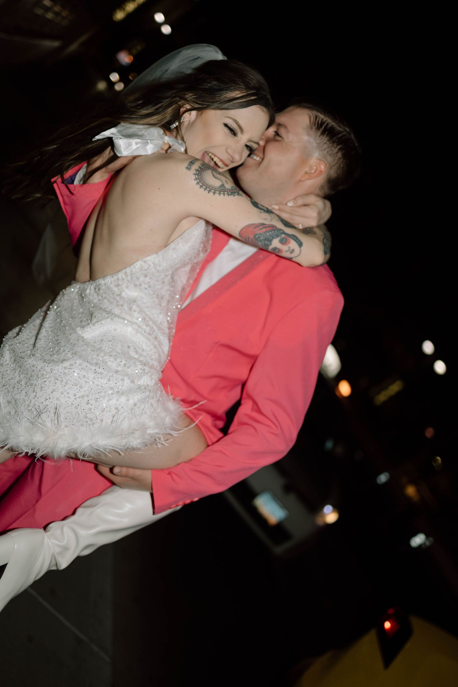 Couple sharing an intimate dance moment under dim lighting at their wedding reception.